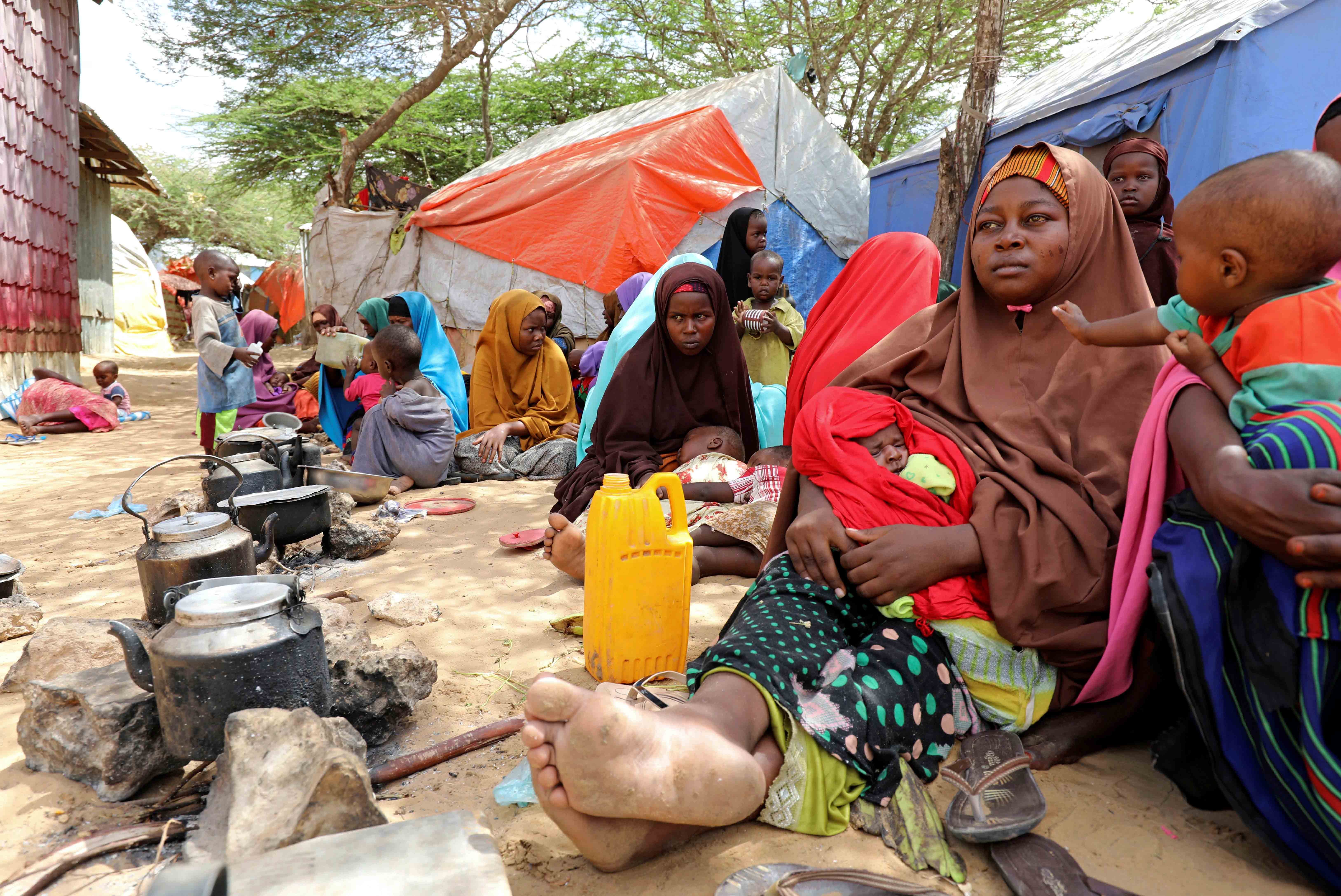 Somali families, displaced after fleeing the Lower Shabelle region amid an uptick in US airstrikes, rest at an internally displaced persons camp near Mogadishu, Somalia, March 12, 2020. © March 12, 2020 REUTERS/Feisal Omar. 