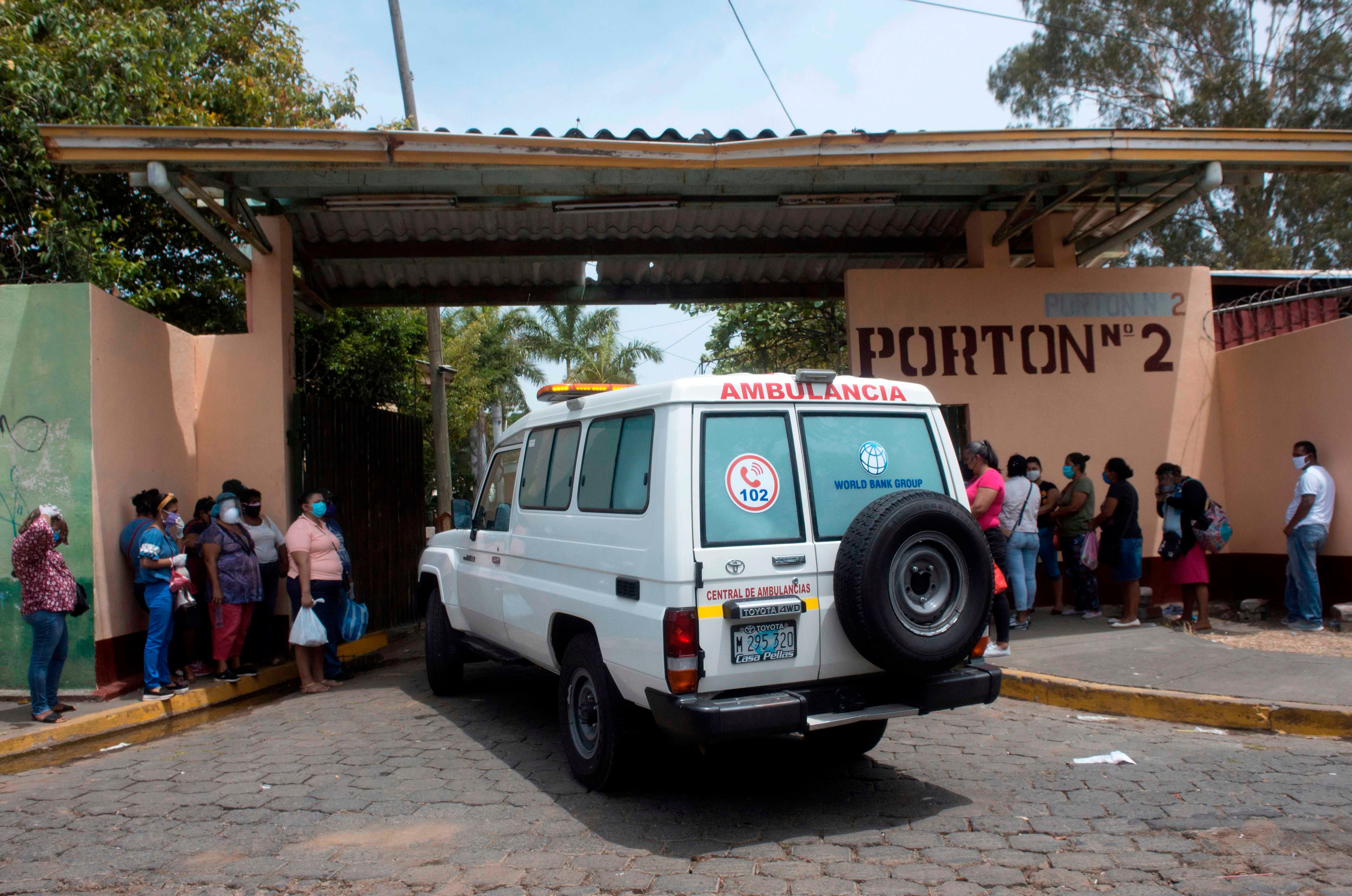  An ambulance enters the Aleman-Nicaraguense Hospital, which cares for people infected with Covid-19, as relatives of patients wait in line in Managua, Nicaragua, on June 1, 2020.
