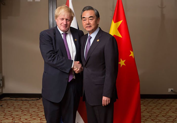 Then-United Kingdom Foreign Secretary Boris Johnson (L) meets with Chinese Foreign Minister Wang Yi at the G20 Foreign Ministers meeting in Buenos Aires, May 2018.