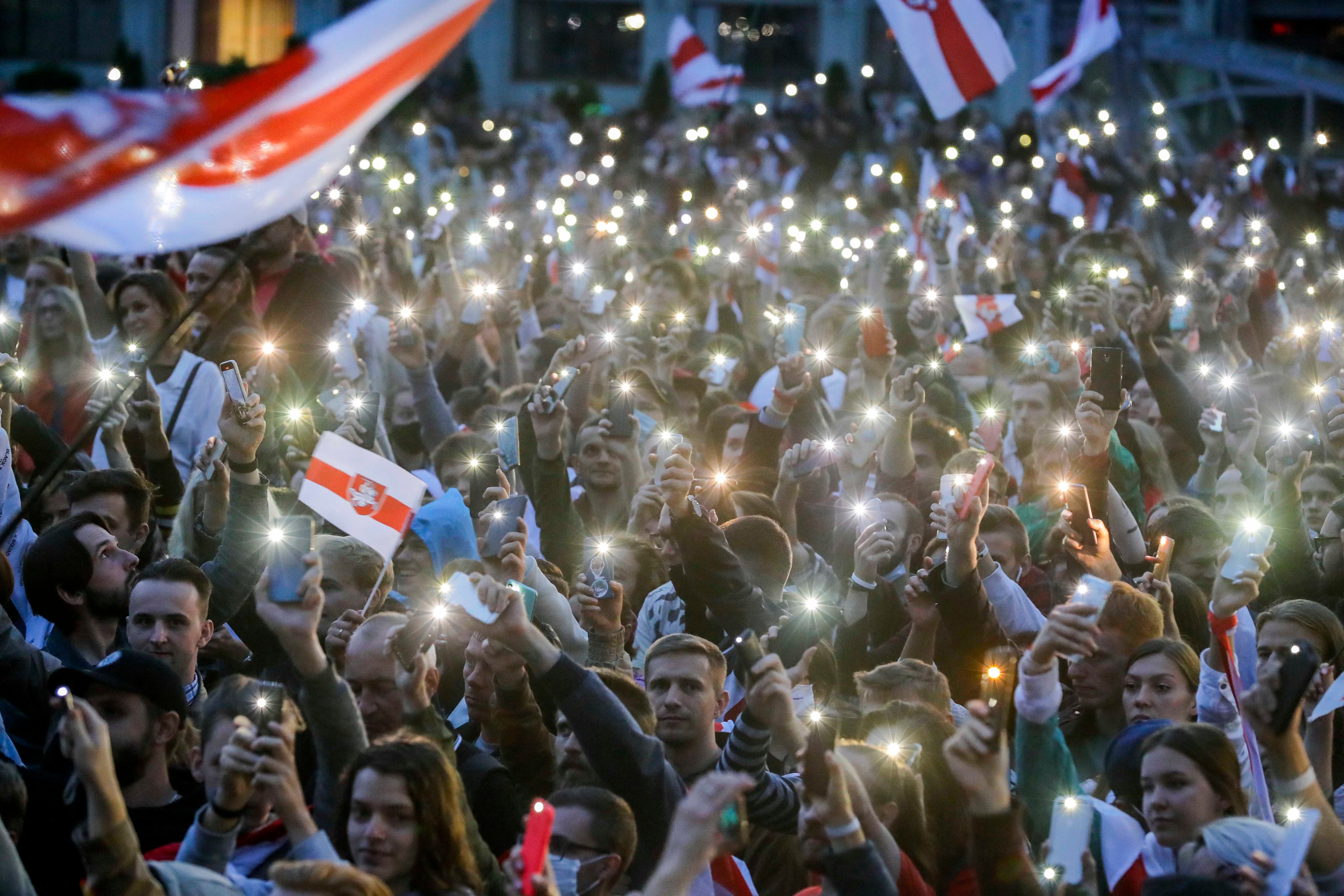 Protesters in Belarus, Minsk, holding up their smartphones. August 25, 2020.
