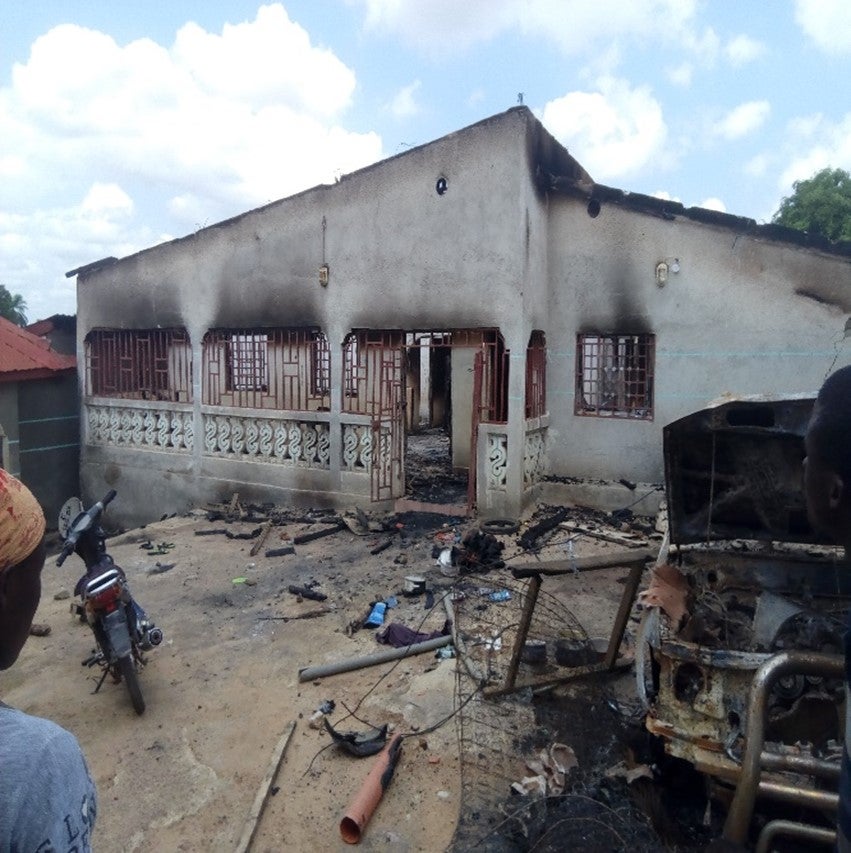 The charred remains of a building and car
