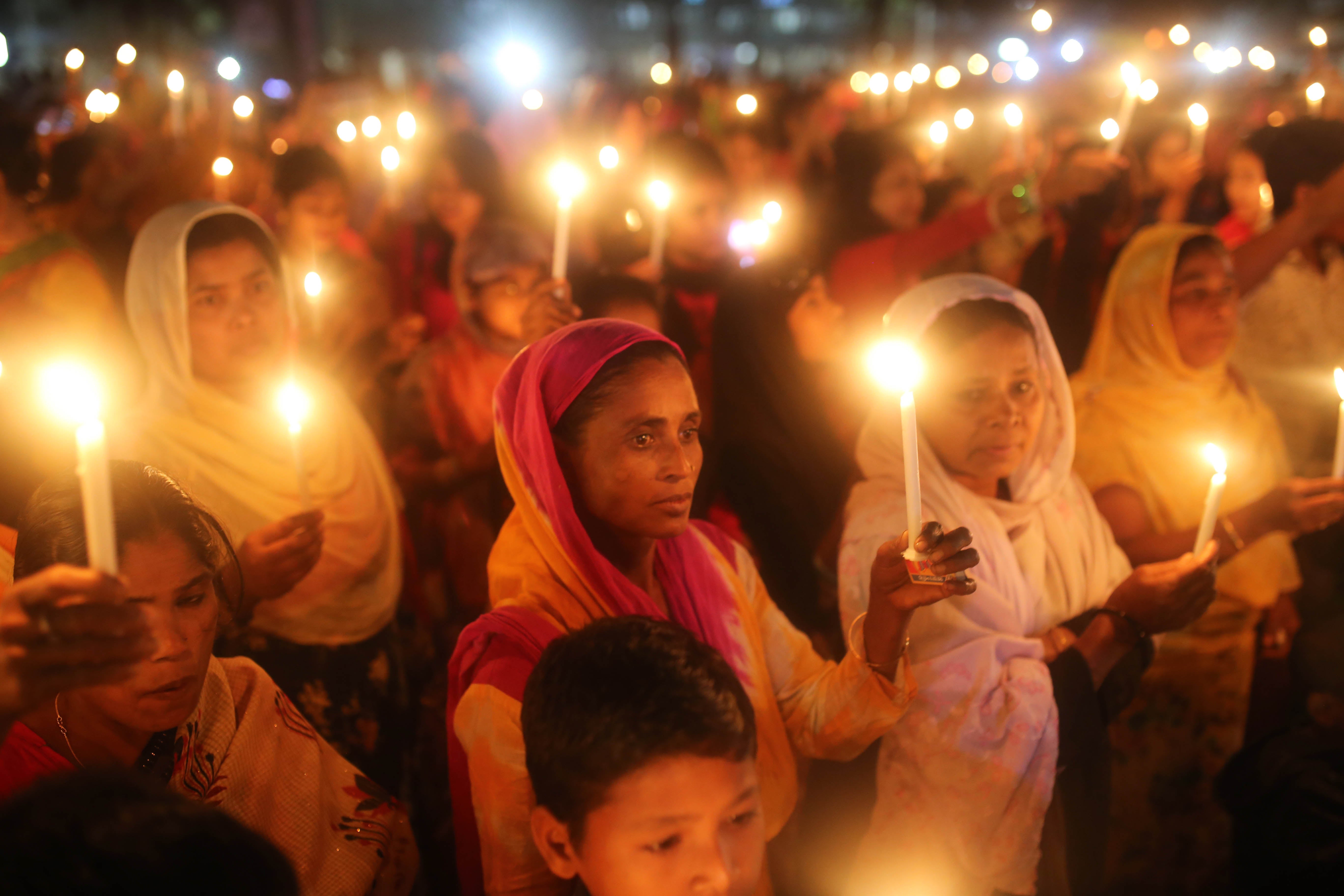A crowd of women holding candles