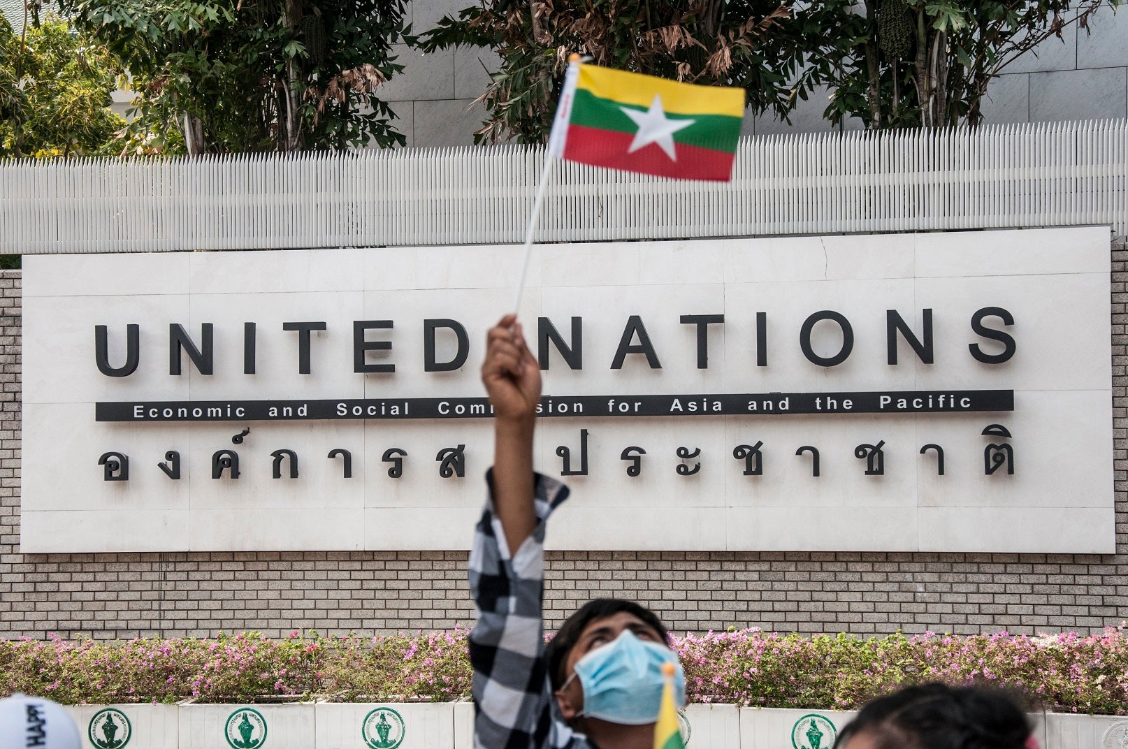 A protester waving a Myanmar nation flag in front of the United Nation building during the demonstration.