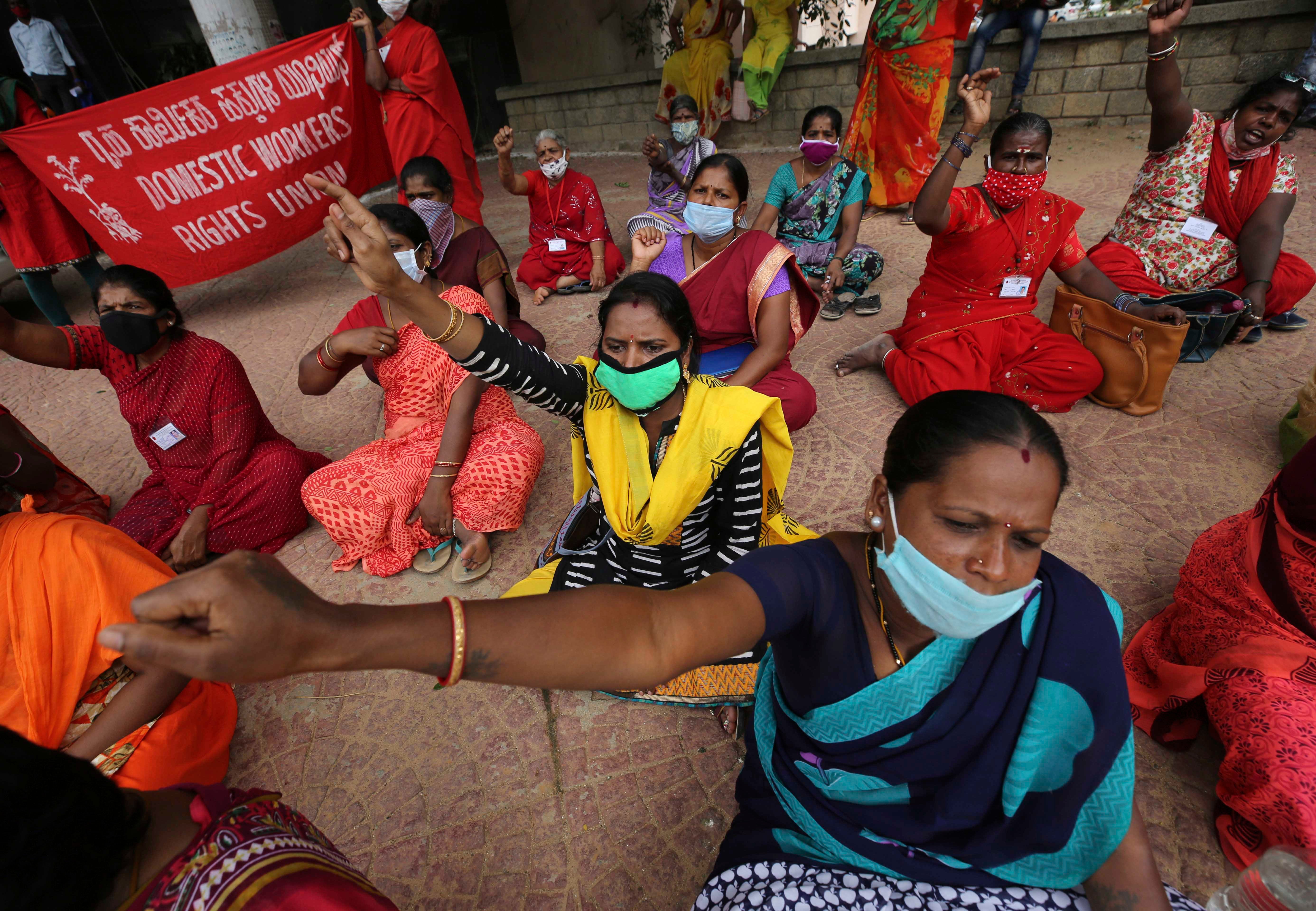 Women domestic workers, many of whom lost their jobs after the coronavirus outbreak, shout slogans at a protest demanding social security from the government in Bengaluru, India, June 15, 2020.
