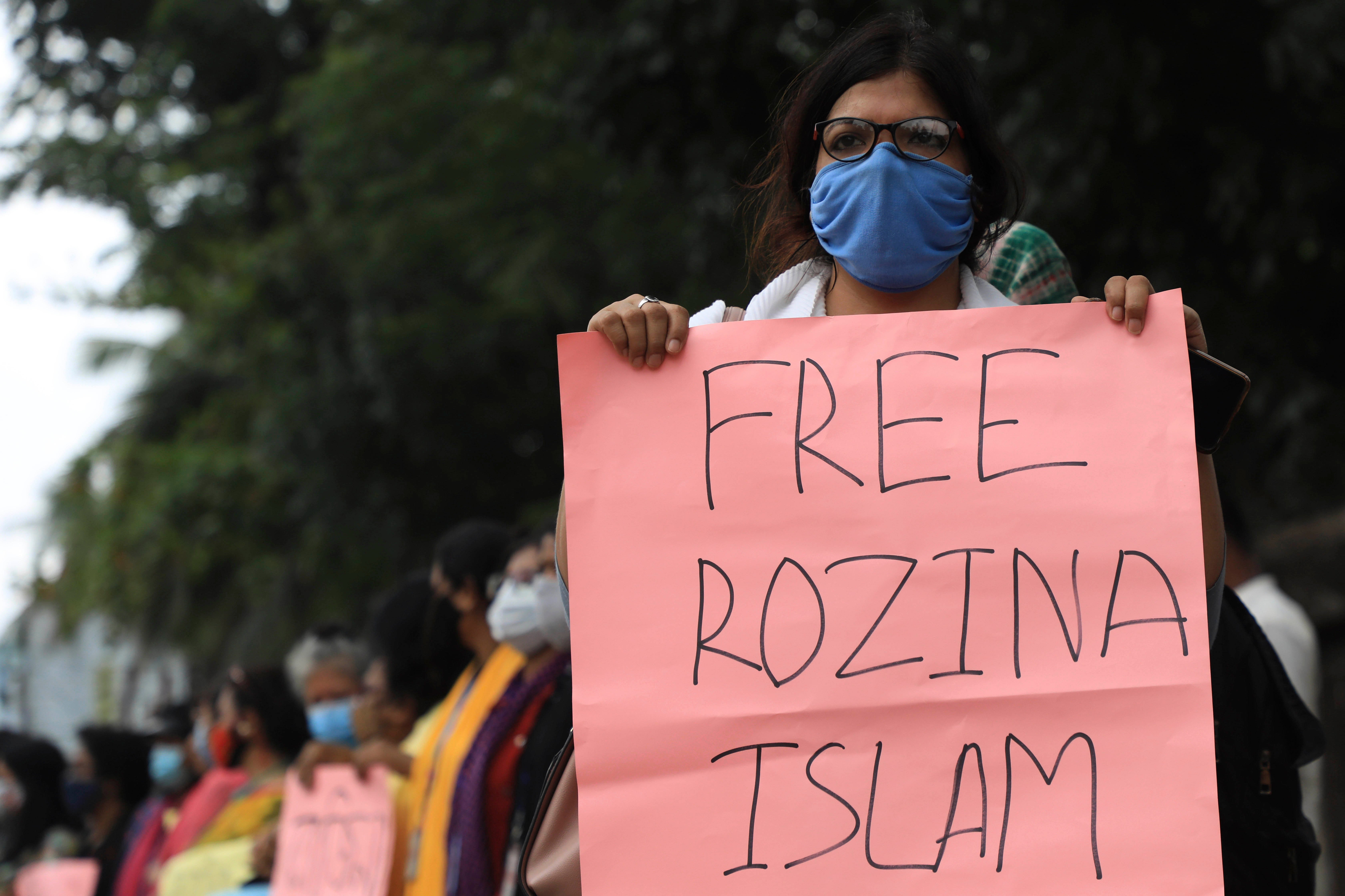 A protester holds a placard reading "Free Rozina Islam " during a demonstration in PLACE on DATE. © 2021 Md Manik/SOPA Images/Sipa USA