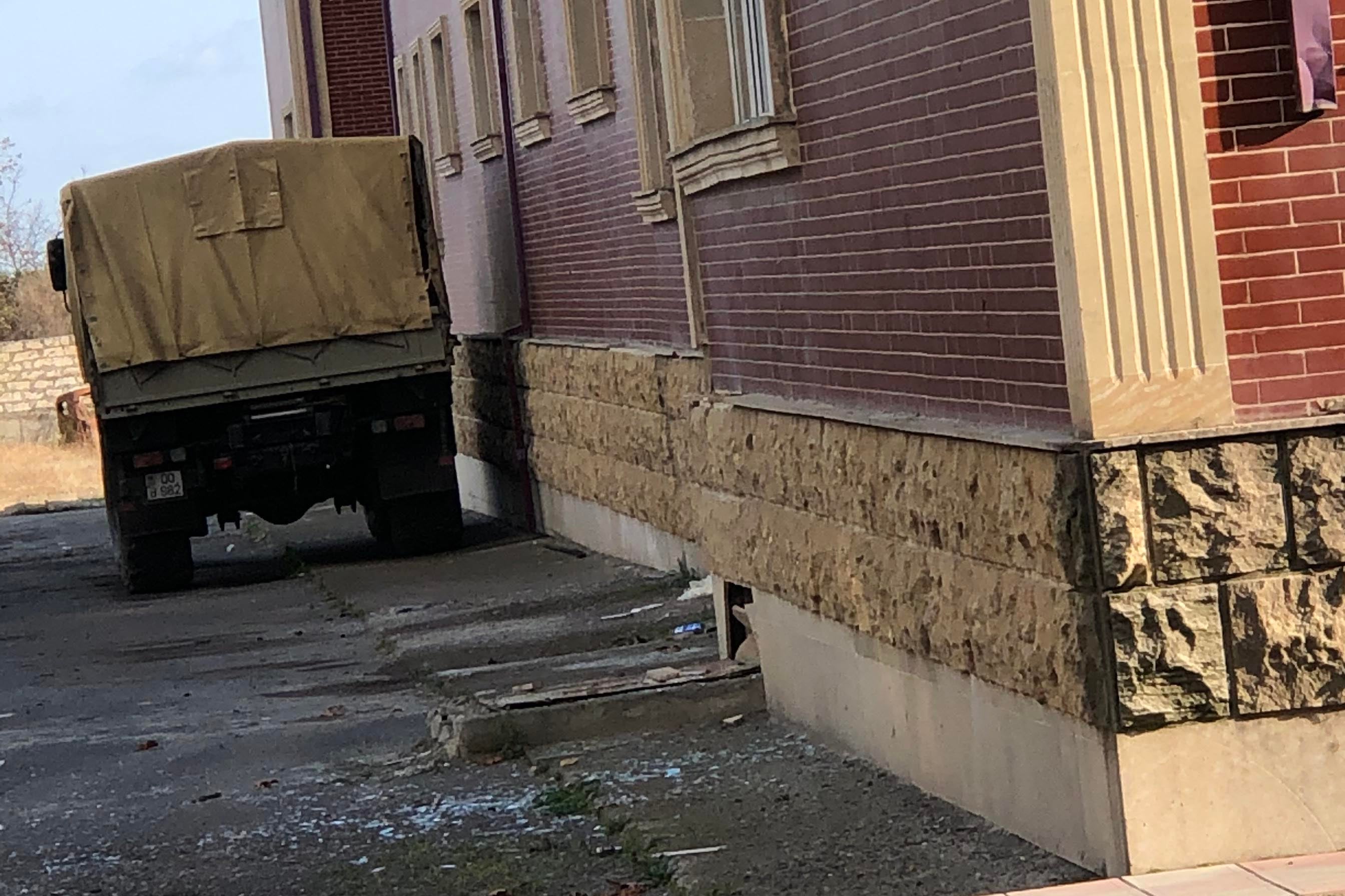 The back of a truck parked next to a building