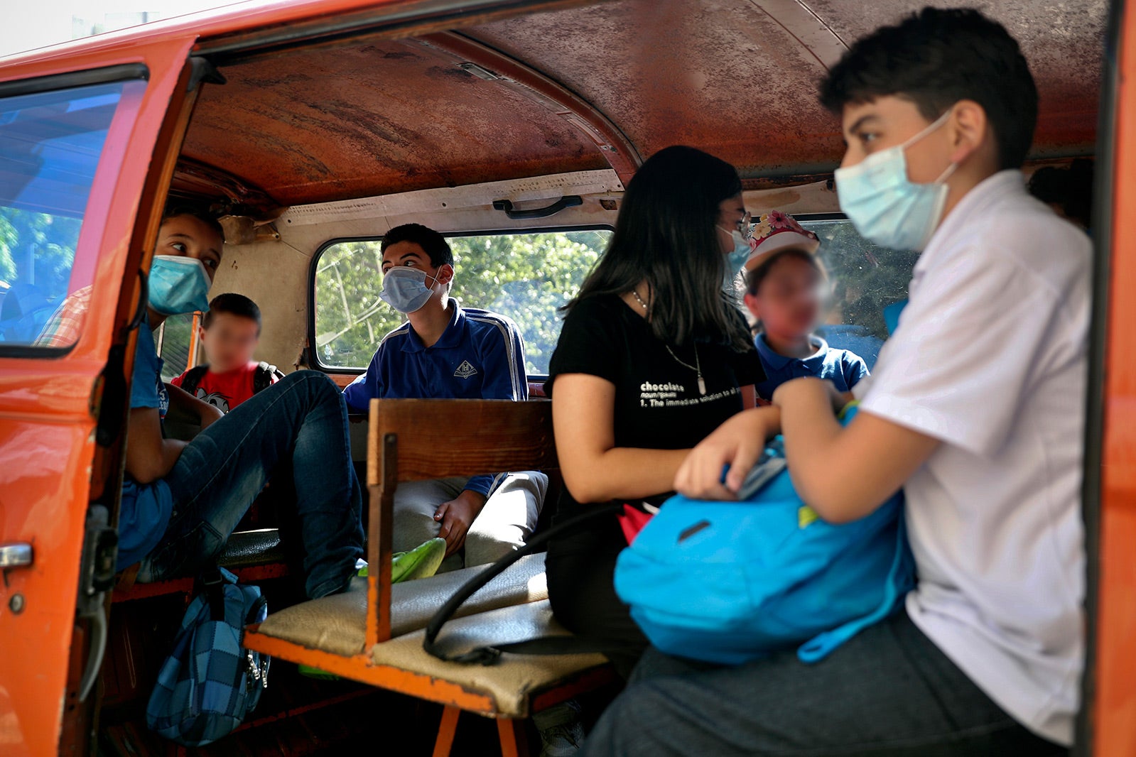 Students sit inside a school bus at the end of their school day in Beirut, Lebanon, 