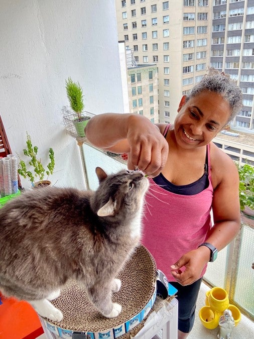 Kaola Baird with her cat on the balcony of her Toronto apartment