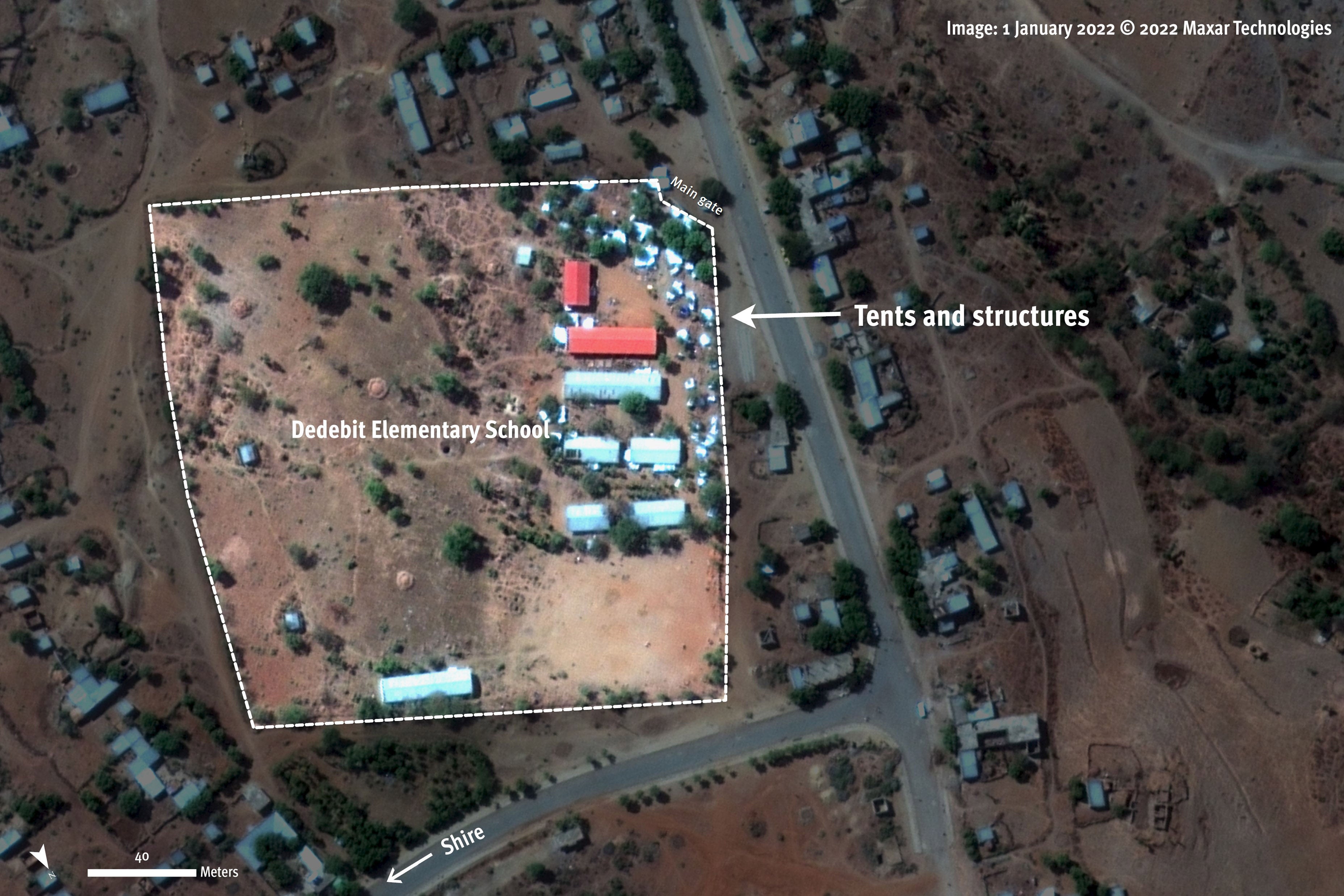 Tents and structures present on the schoolyard of Dedebit Elementary School, days before the January 7, 2022 attack.