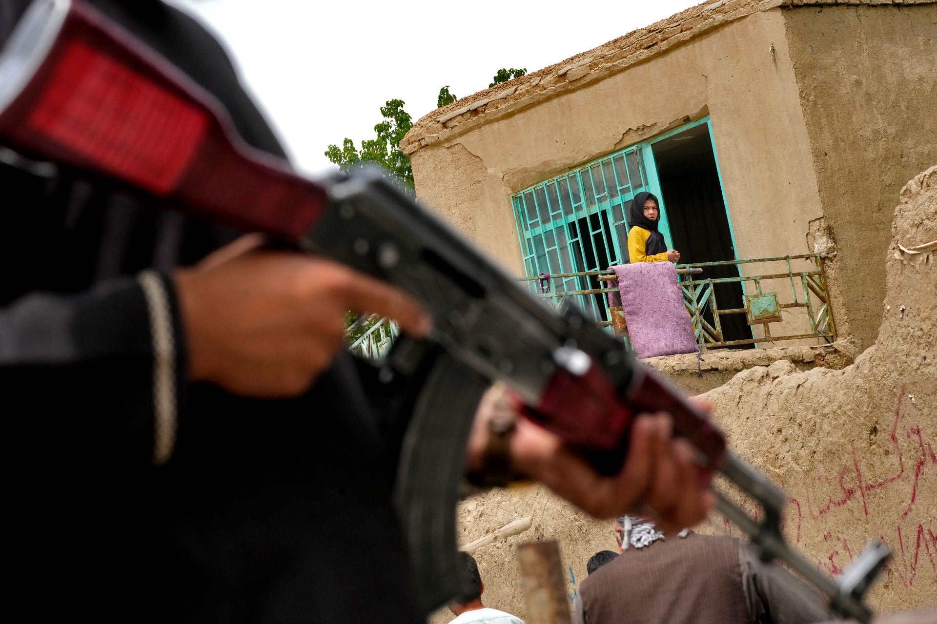 A Taliban fighter stands guard at the site of an explosion in front of a school, in Kabul, Afghanistan, April 19, 2022.