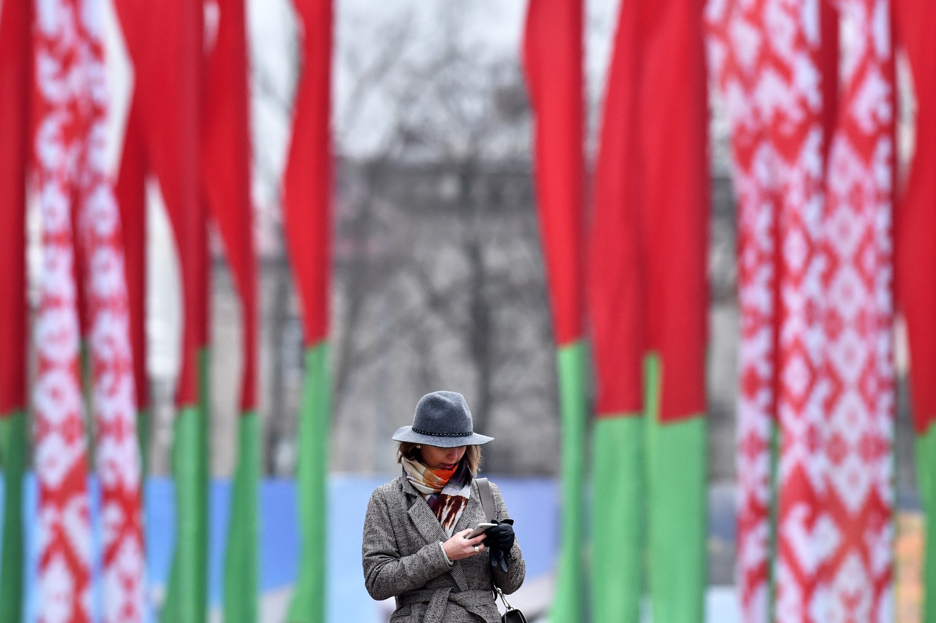 A woman looks at her mobile phone