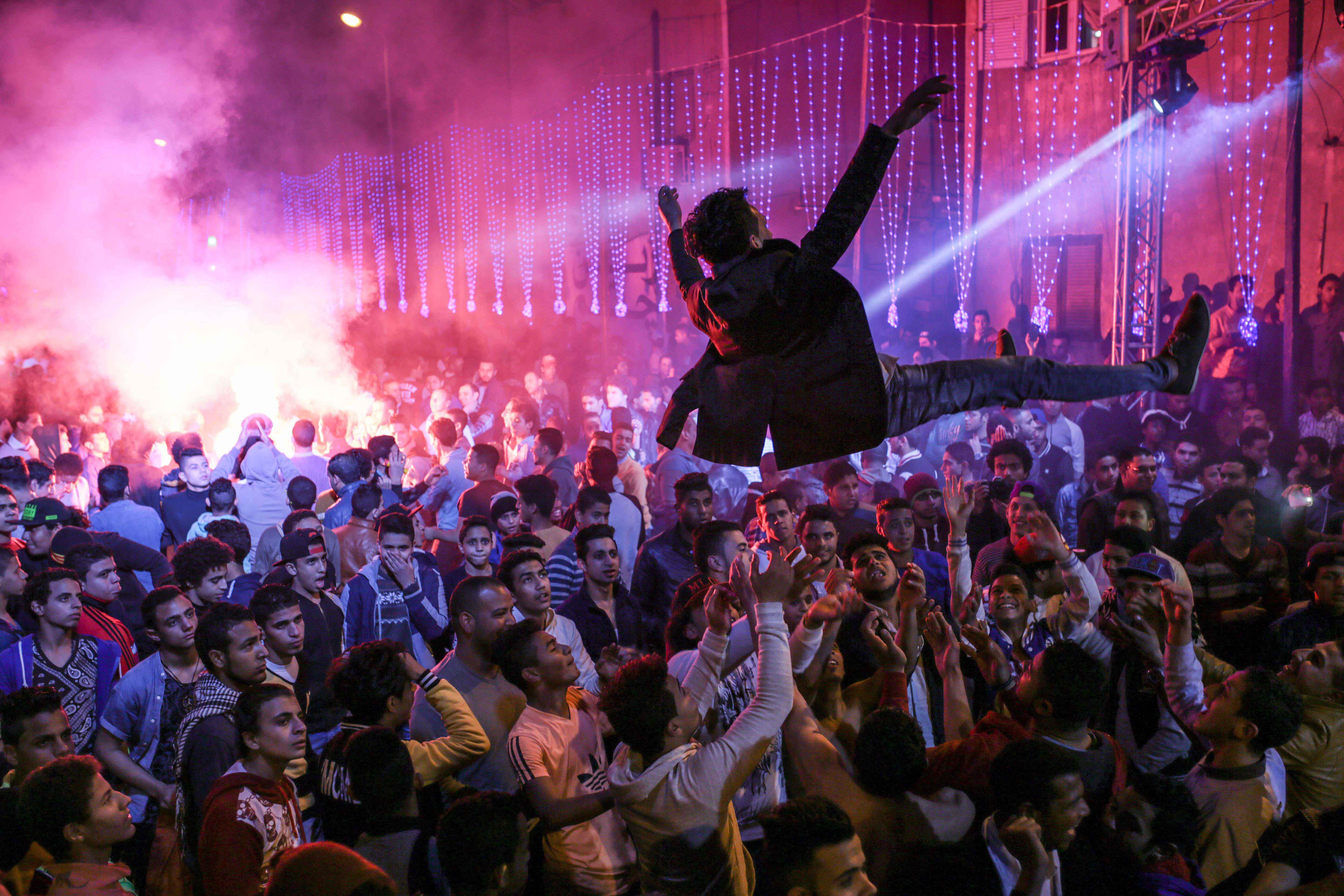 Youth dance to Mahraganat music at a wedding in Salam City, a suburb of Cairo, March 5, 2015.