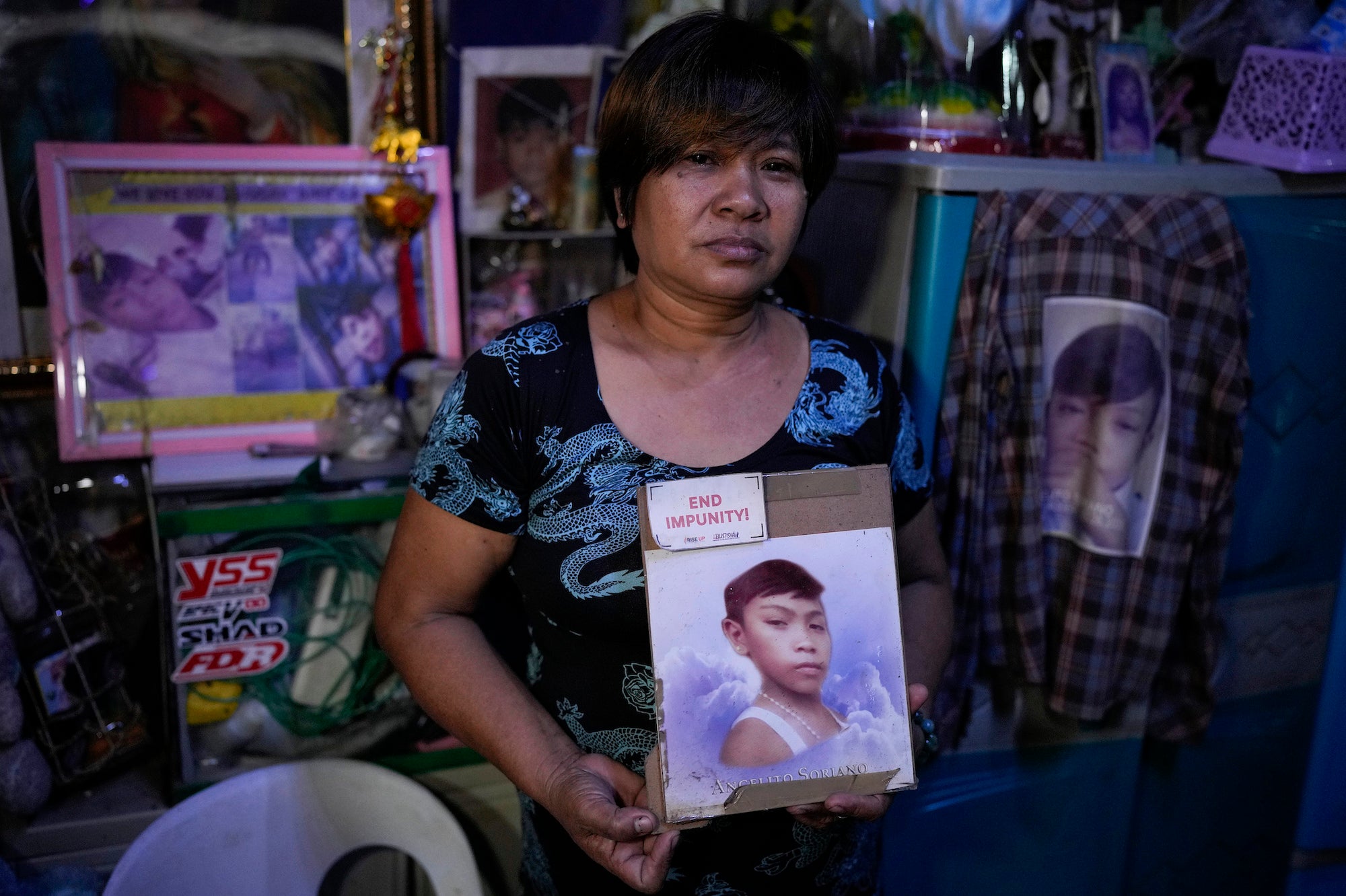Mother holding a photo of her deceased son.