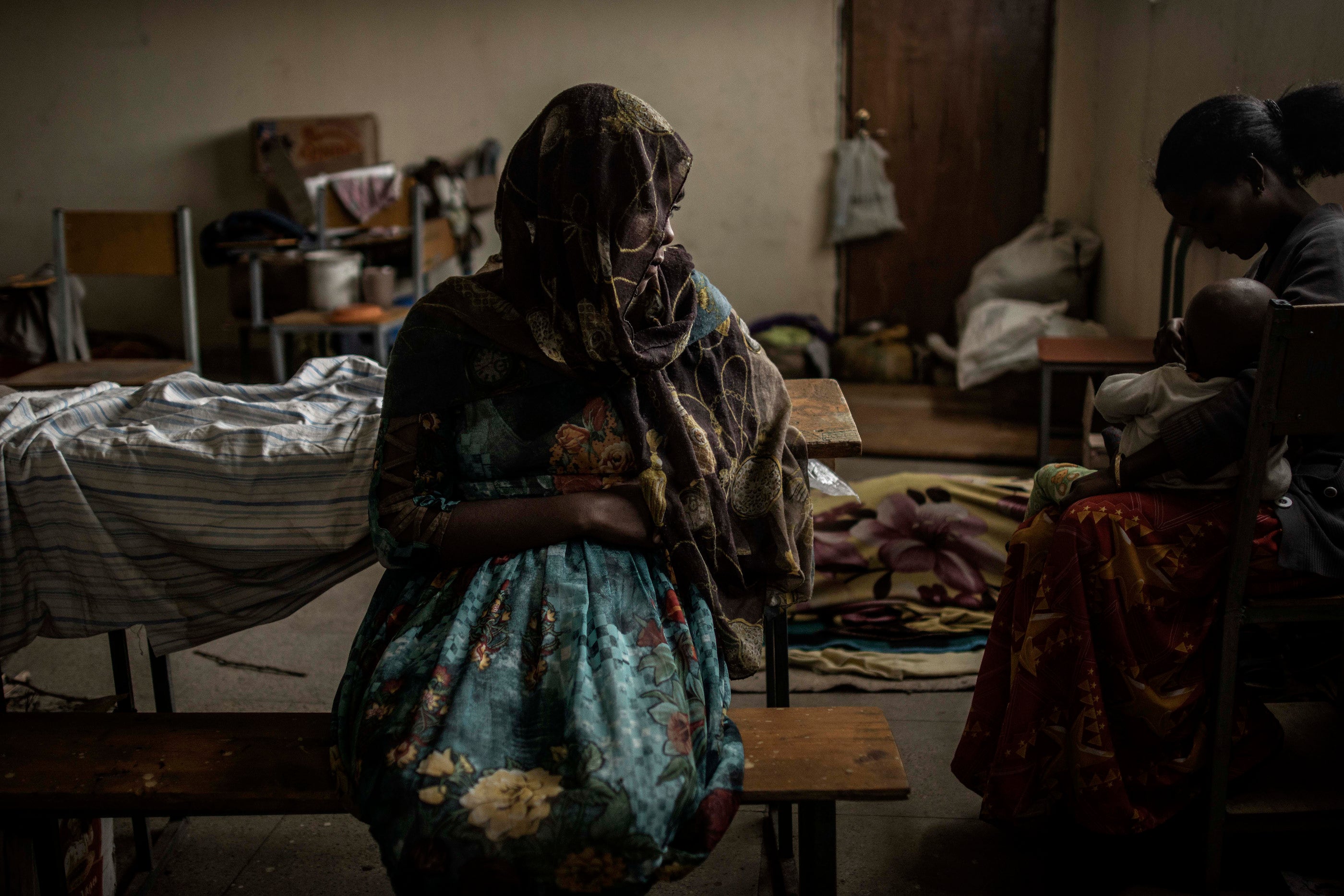 A woman sits at a school being used to house people displaced by fighting, in the city of Mekelle in Ethiopia's northern Tigray region.