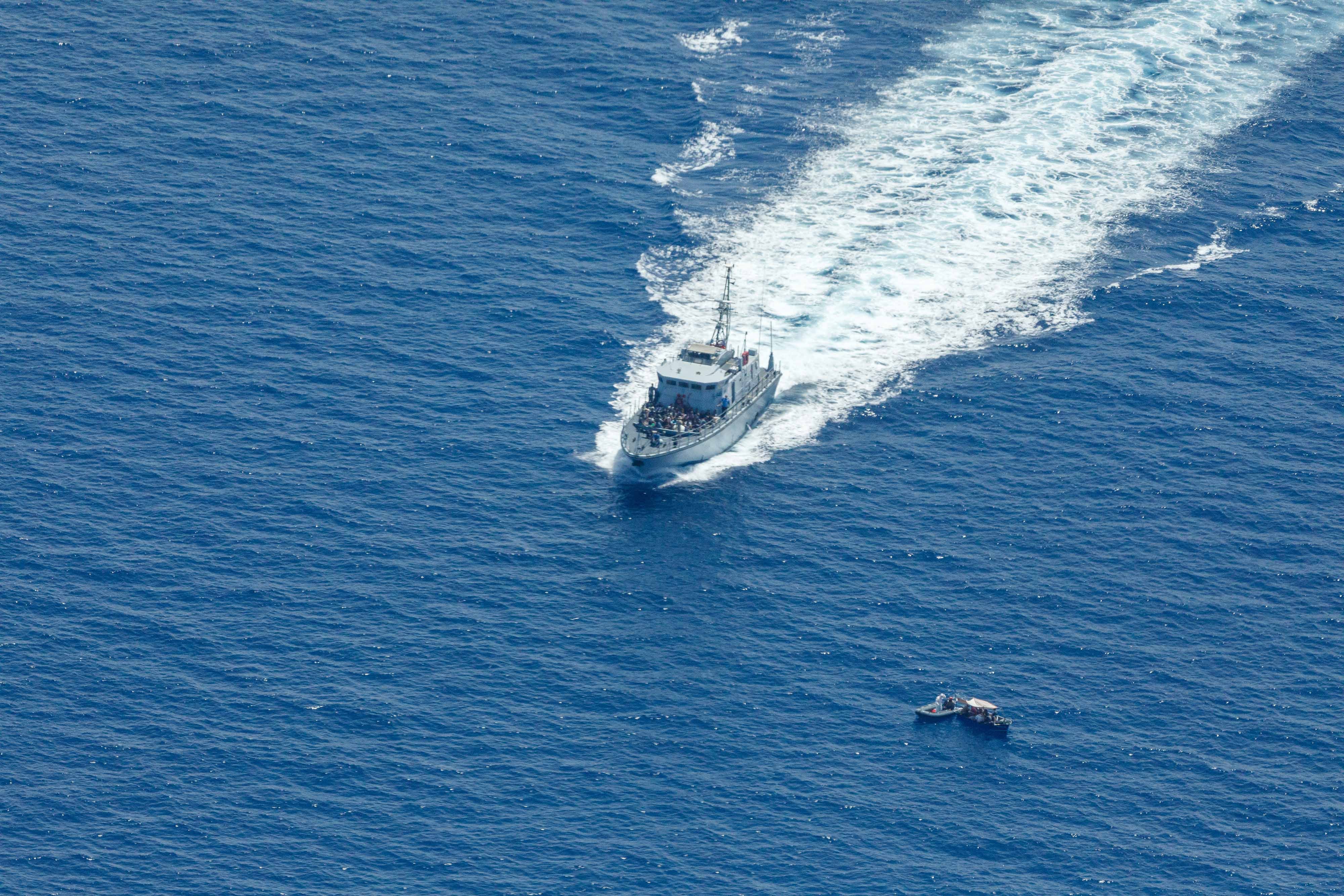 Libyan Coast Guard patrol boat Ras Jadir intercepts a wooden boat in the Mediterranean Sea, July 30, 2021. 