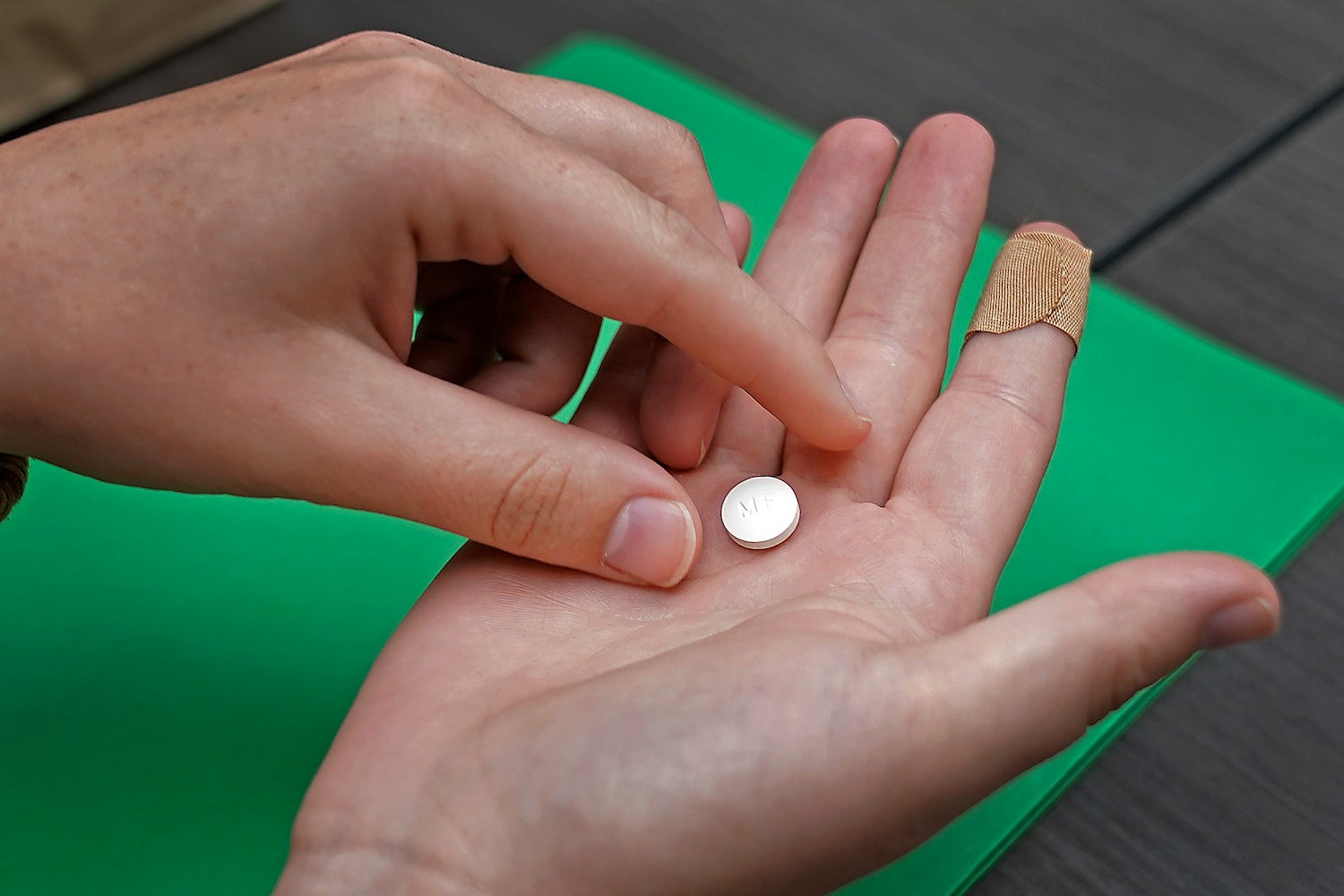 A patient in a Kansas clinic prepares to take the first of two pills for a medical abortion.