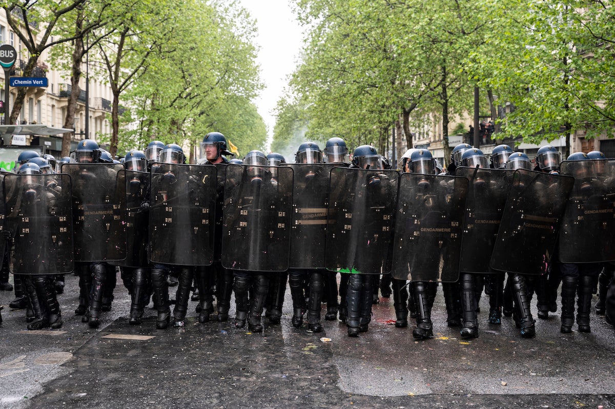 Riot police from the Gendarmerie Mobile advance in line as thousands of demonstrators take part in the traditional May Day demonstration, Paris, France.