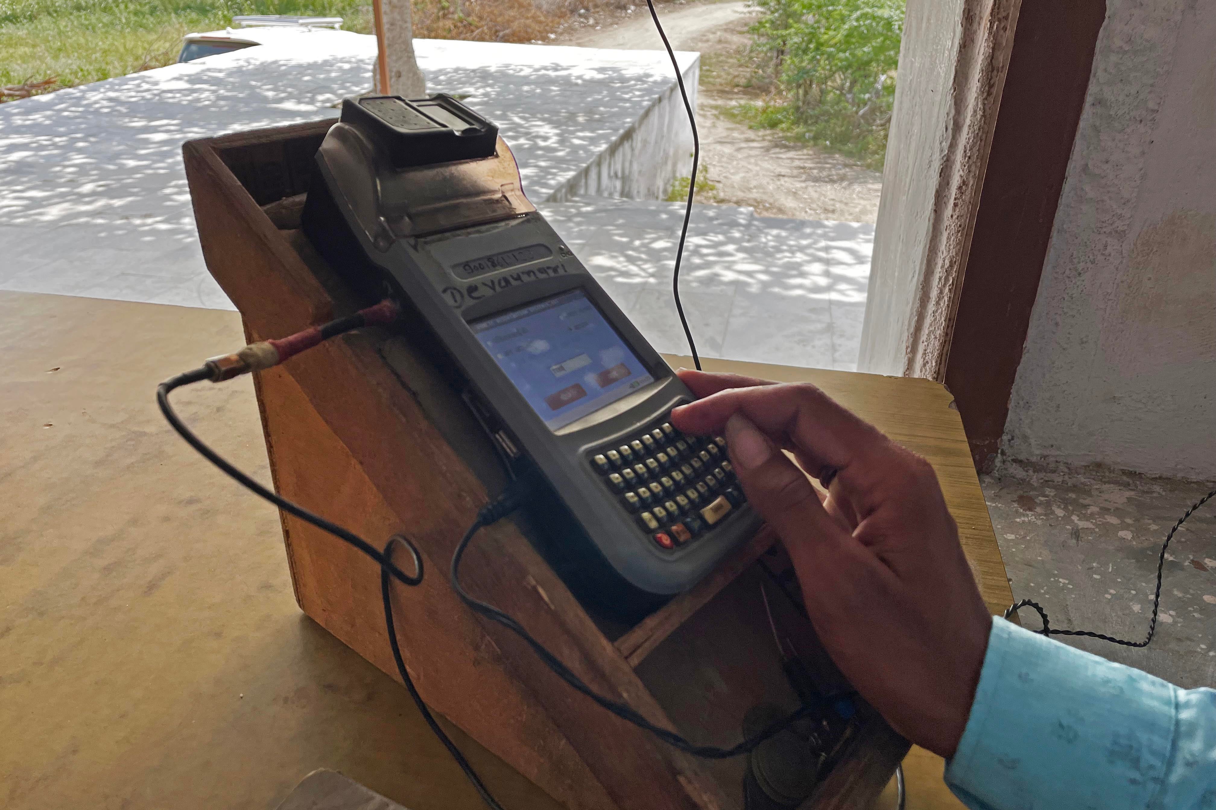A man uses a machine for biometric authentication