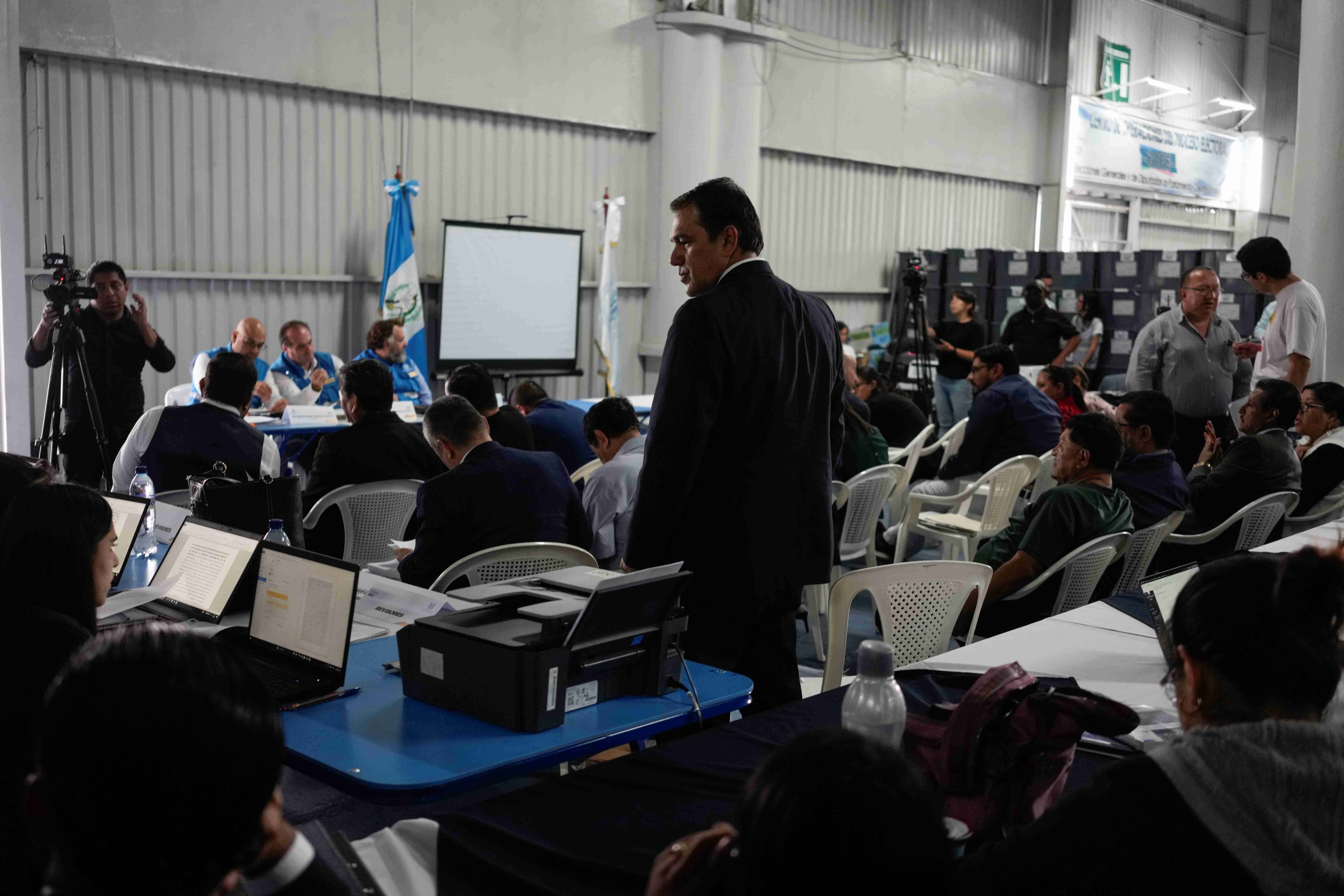 Electoral authorities review records in a meeting with political parties' lawyers in Guatemala City, July 4, 2023, after the Constitutional Court ordered an investigation in response to a case brought by political parties whose candidates lost in the preliminary tabulation of ballots.