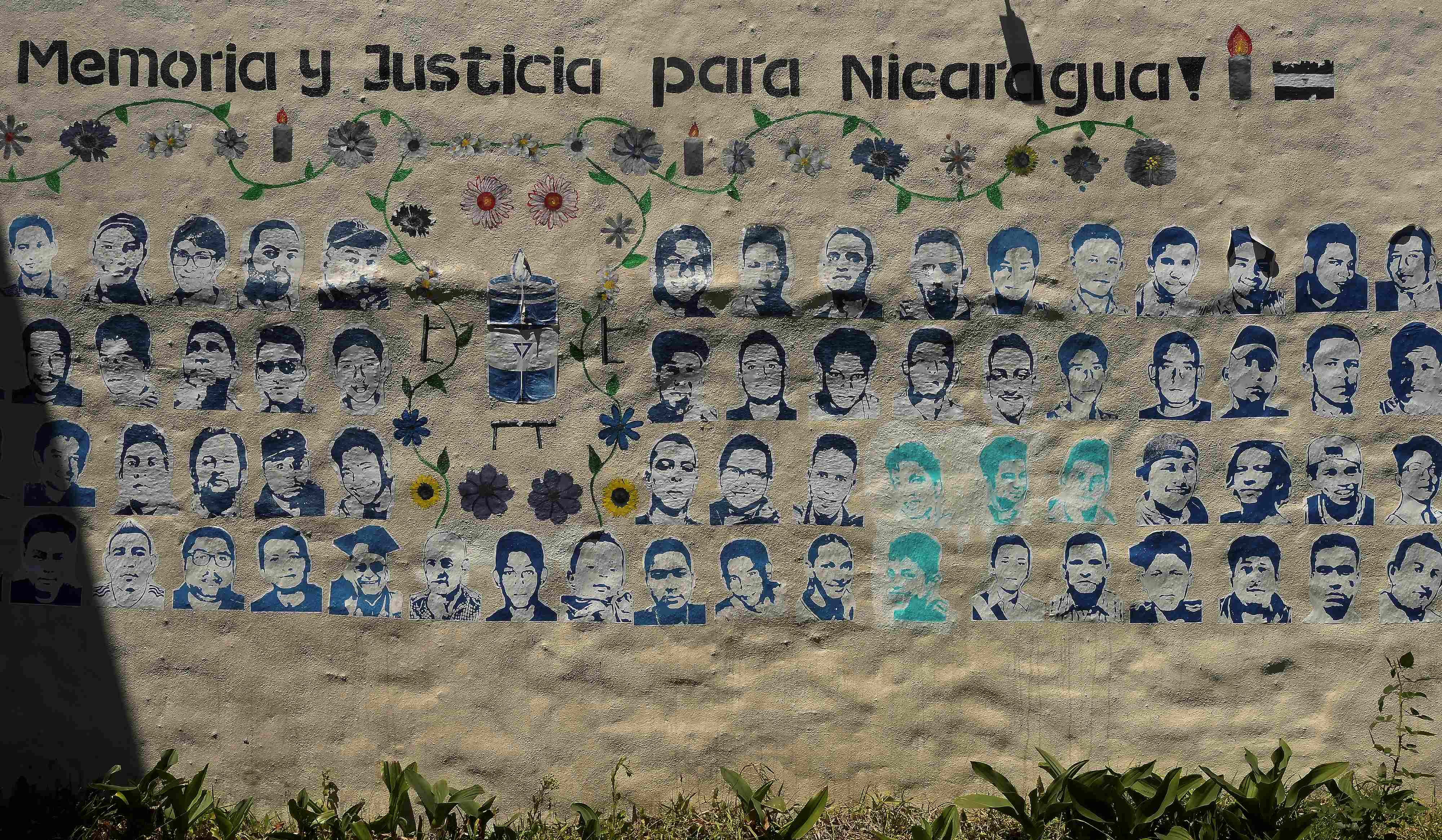 A mural showing images of Nicaraguans killed during the 2018 social security reform protests under the words “memory and justice for Nicaragua”  adorns a wall at the Nicaragua Nunca Más human rights organization in San Jose, Costa Rica, February 20, 2023.