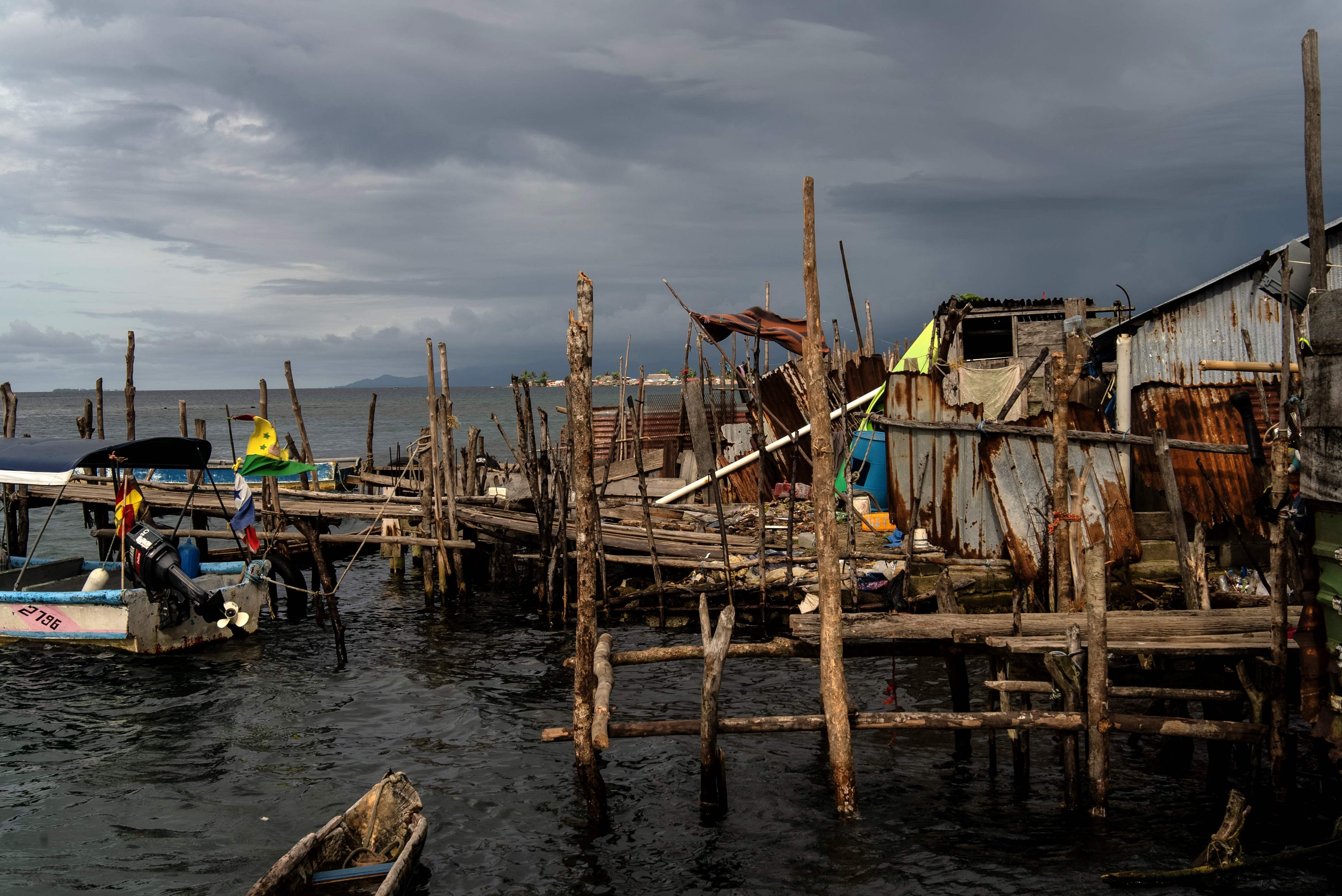 Dark clouds over homes on an island