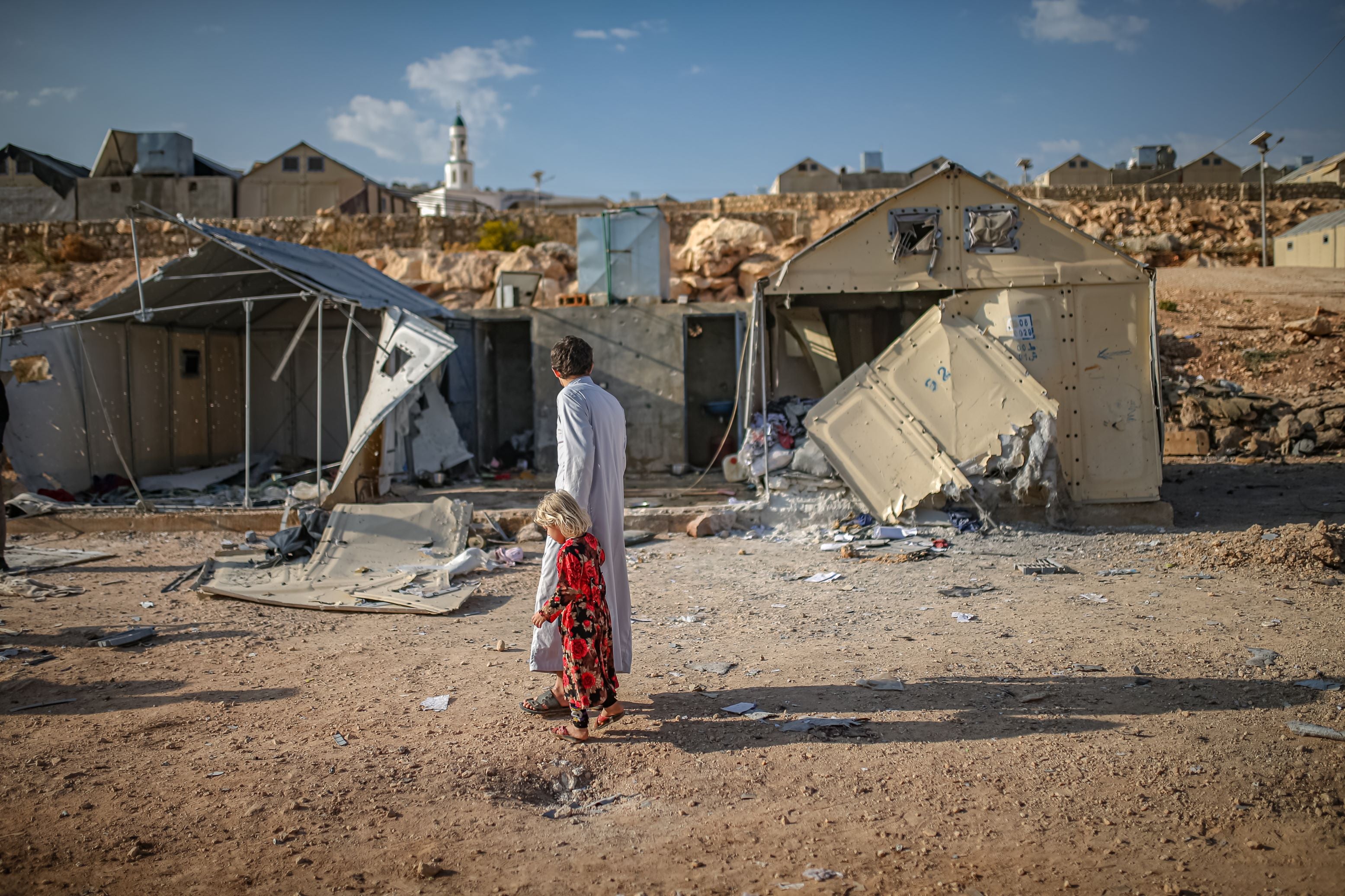People assess the damage caused by the Syrian-Russian military alliance’s cluster munition attack on the Maram camp for displaced people near the village of Kafr Jalis in Idlib governorate, northwestern Syria, on 6 November 2022. 