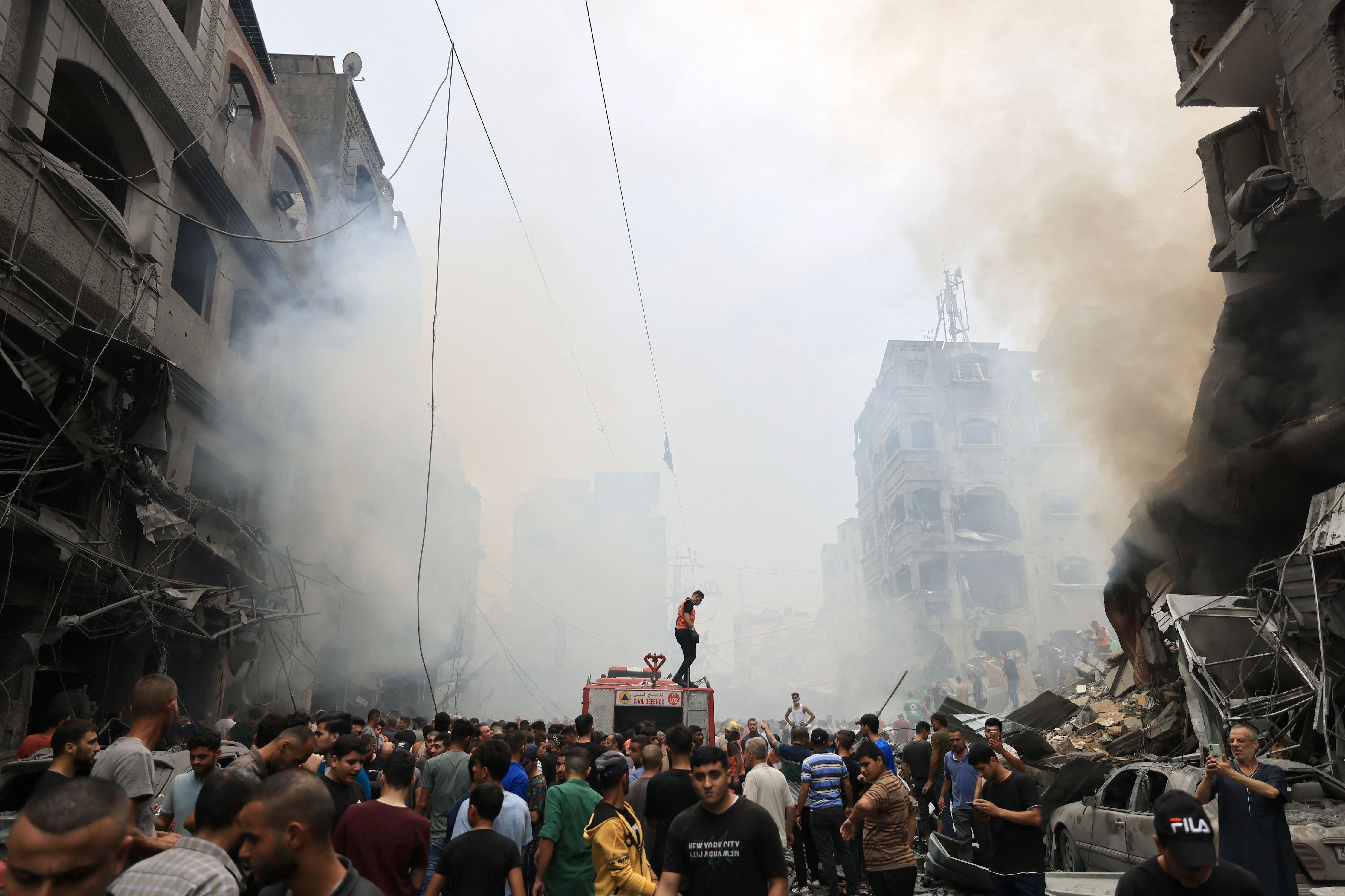 Palestinians search for survivors after an airstrike on buildings in the refugee camp of Jabalia in the Gaza Strip on October 9, 2023. 