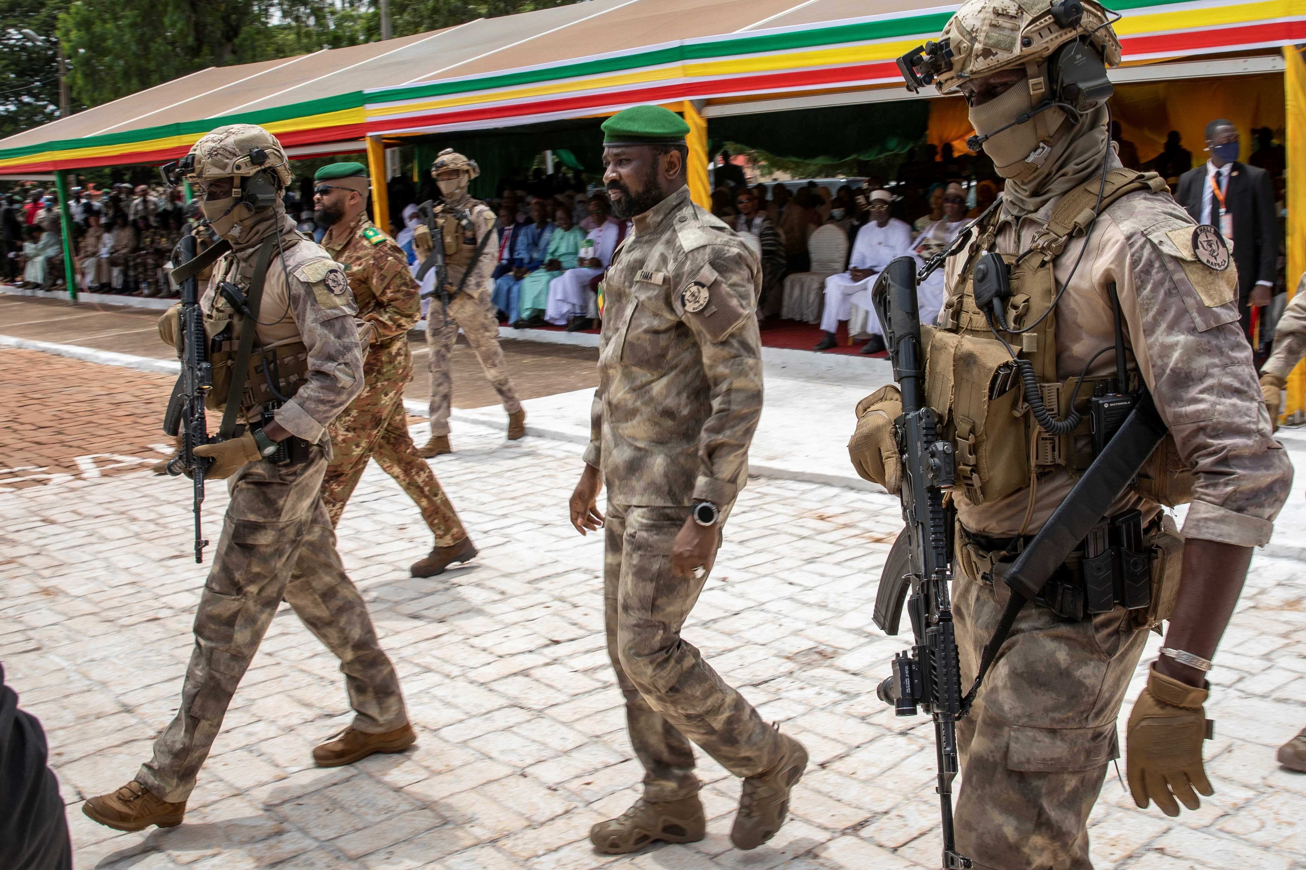 The leader of Mali’s junta, Lt. Col. Assimi Goita, center, attends an independence day military parade on September 22, 2022, in Bamako, Mali. 