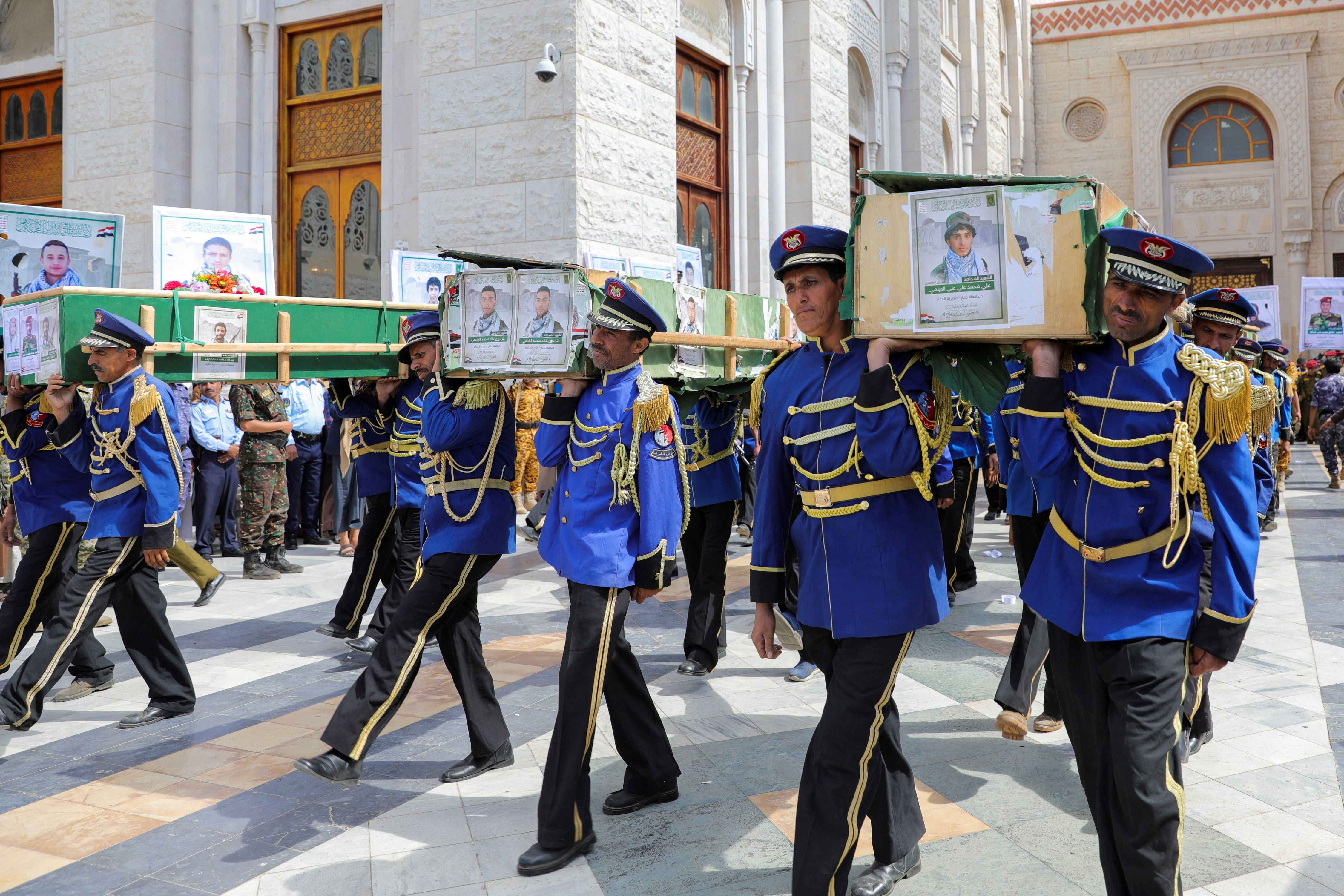 Honor guards carry the coffins of Houthi fighters killed by US-led airstrikes during a funeral in Sanaa, Yemen, February 10, 2024. 