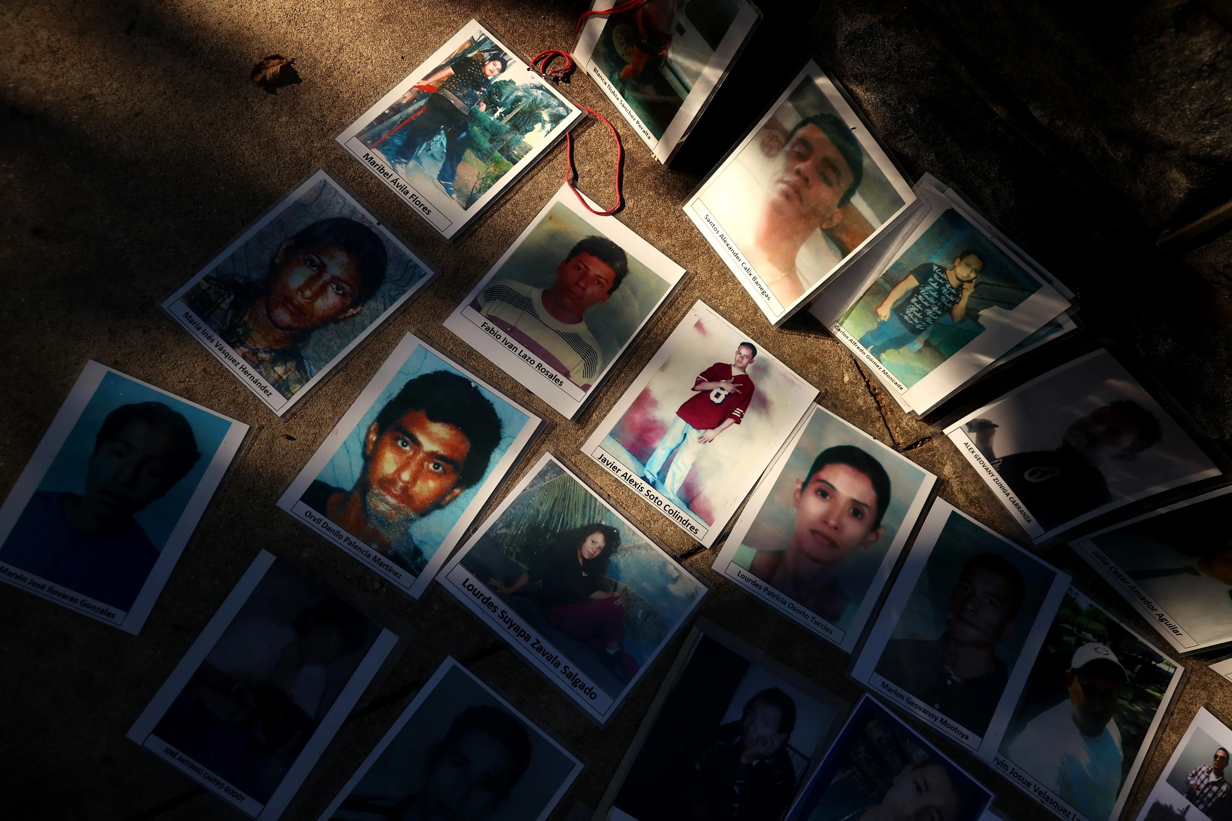 Photographs of people who disappeared while attempting to migrate to the United States are laid out across the street from the US Capitol in Washington, DC, October 19, 2021. 