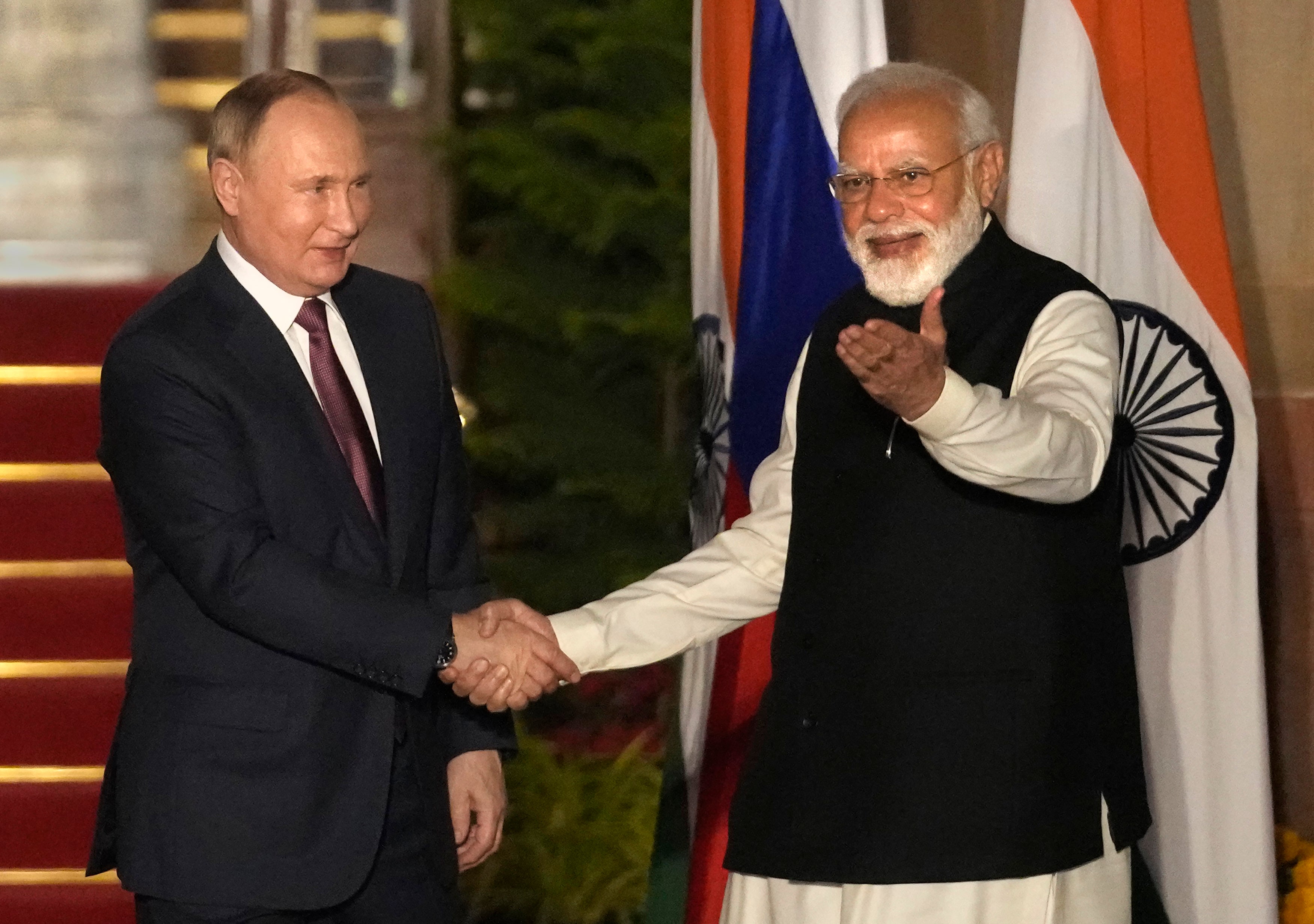 Russian President Vladimir Putin and Indian Prime Minister Narendra Modi greet each other before their meeting in New Delhi, India, December 6, 2021.