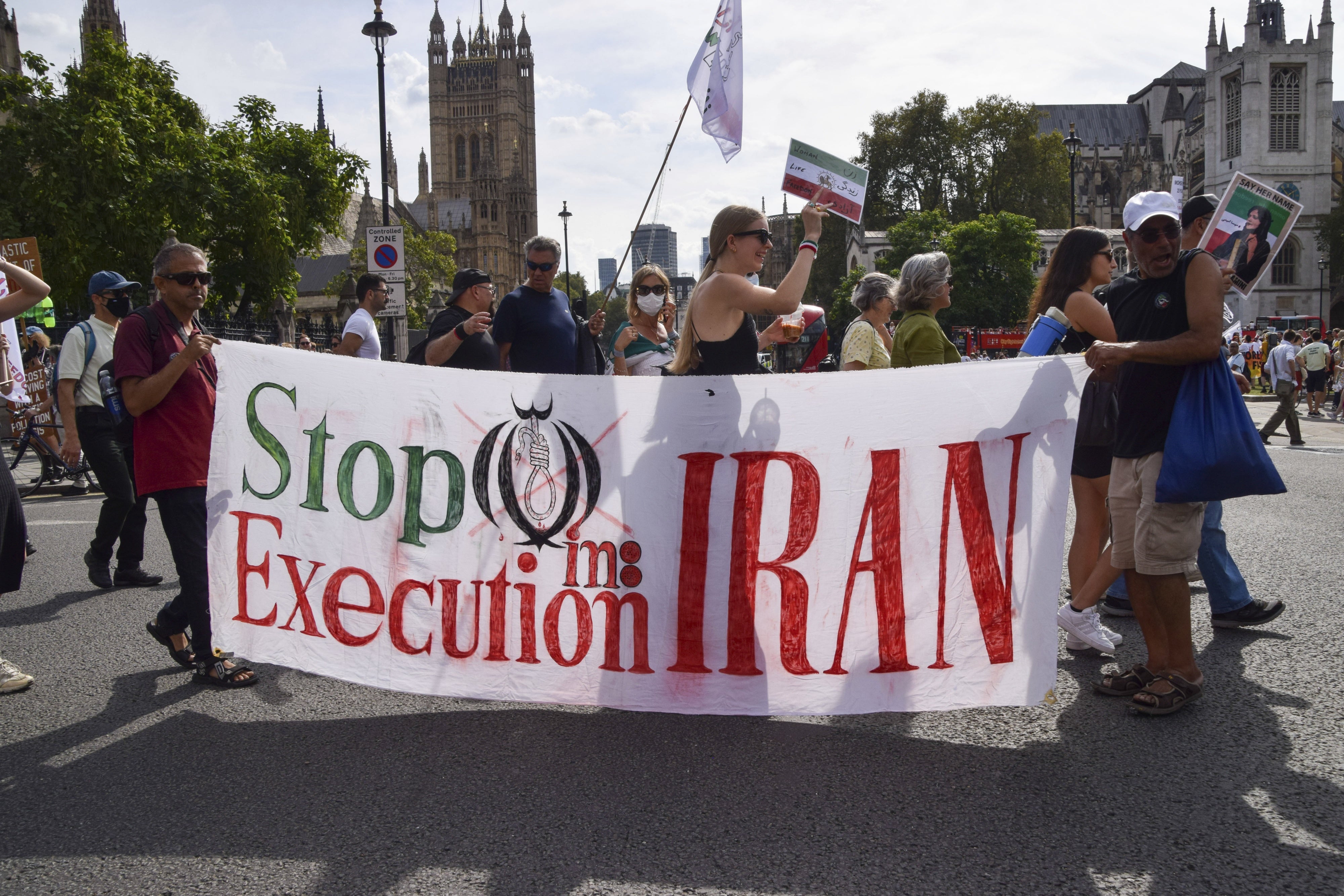 Protesters hold a banner reading 'Stop execution in Iran' during a march in Parliament Square, London, September 16, 2023. 