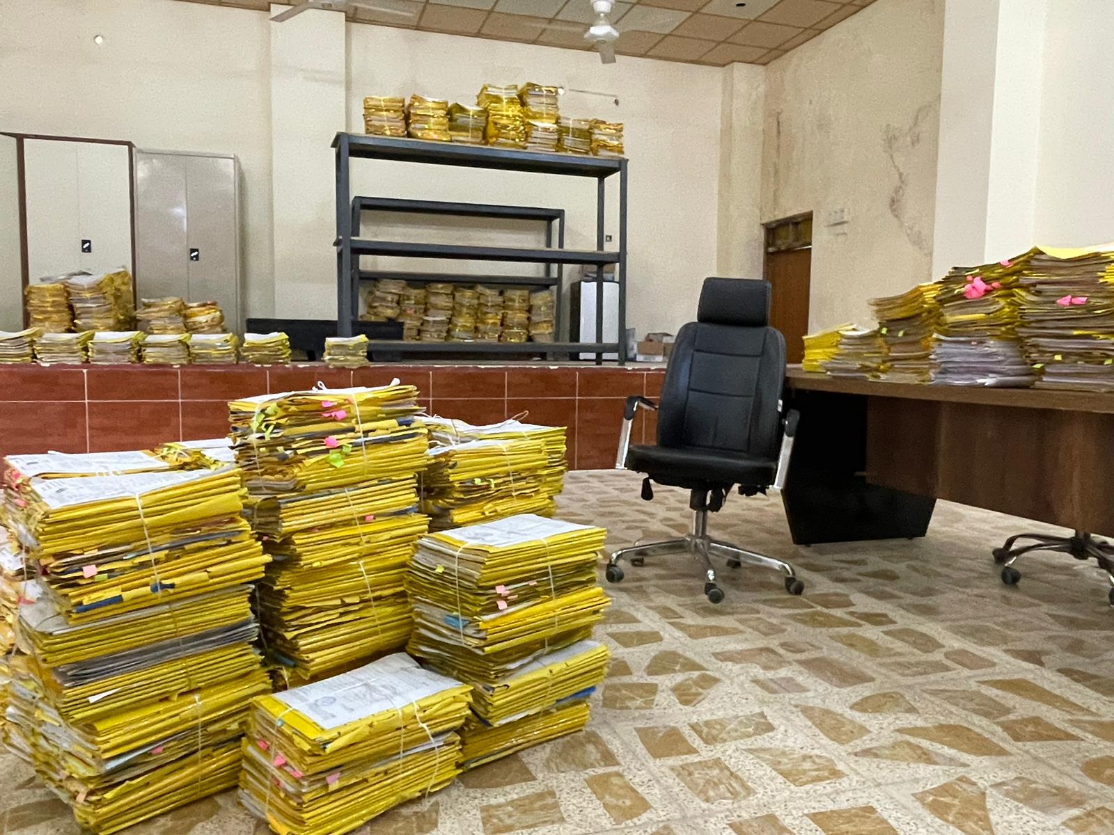 Piles of applications in the Tel Afar compensation office. 