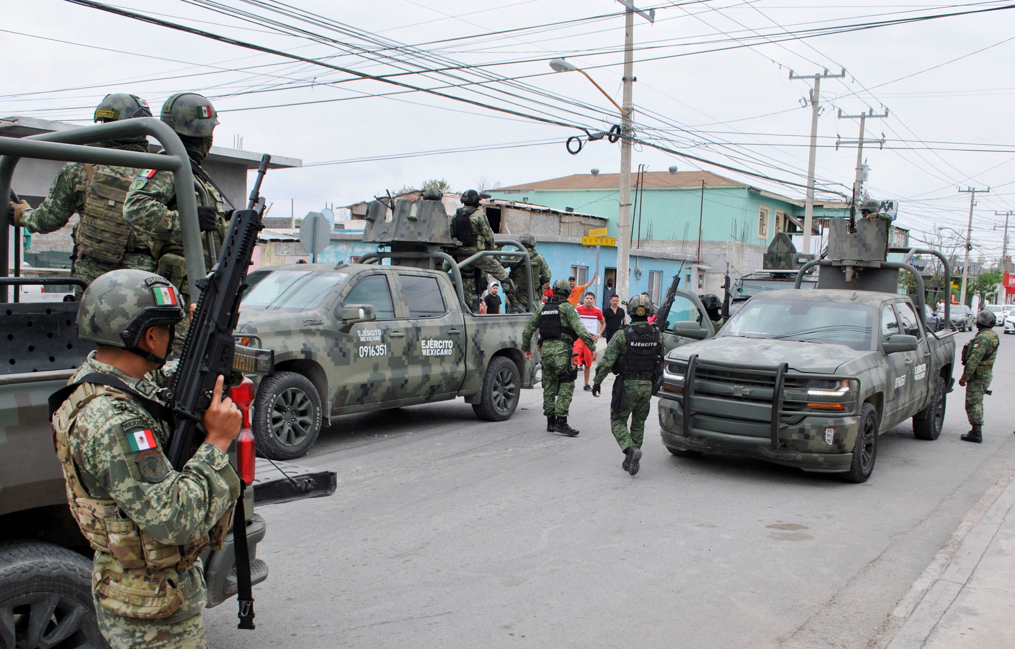 People argue with soldiers on a street 