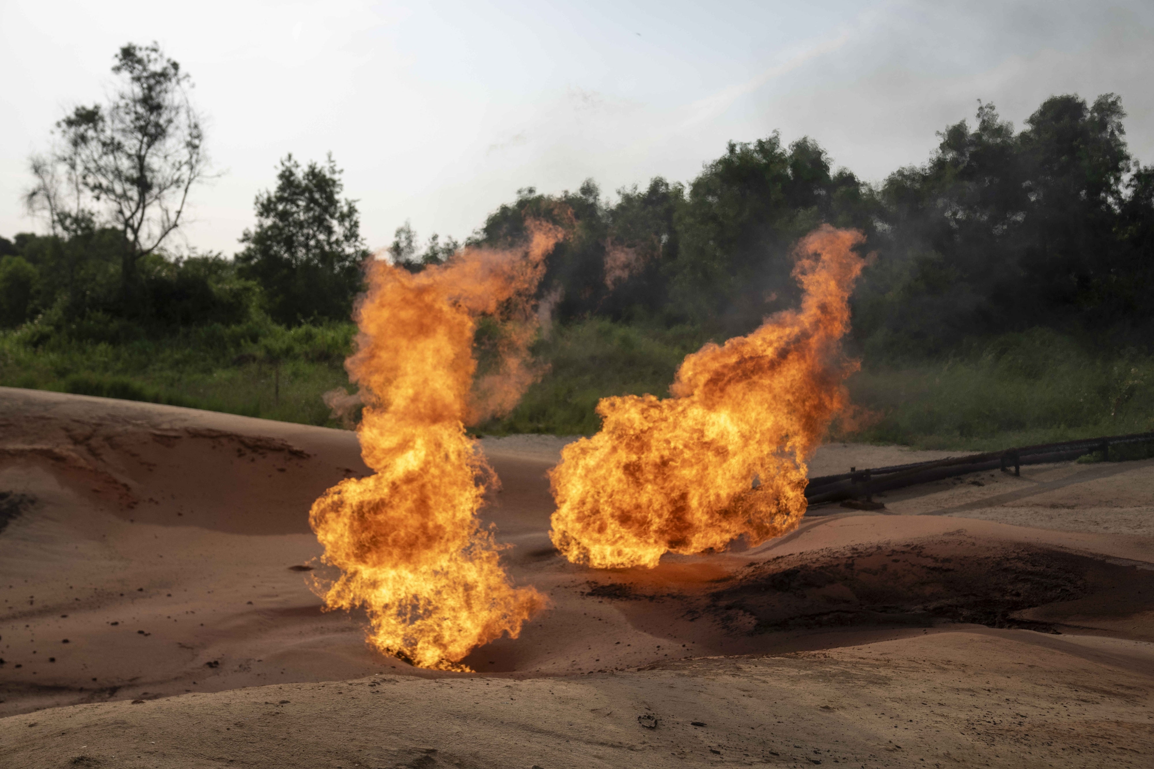 A burning flare is visible at an oil extraction area located in Moanda, Democratic Republic of the Congo, December 23, 2023.