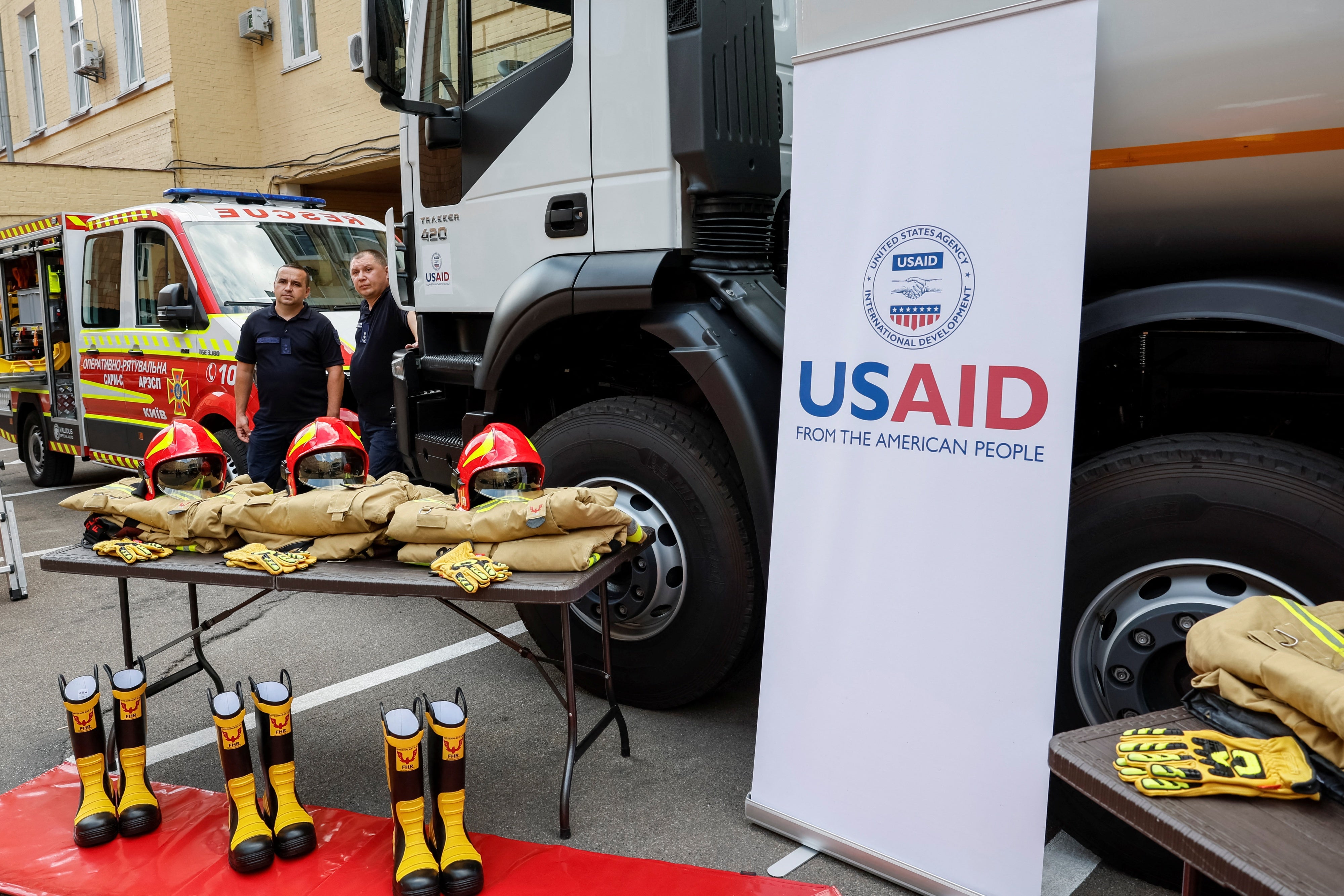 Ukrainian rescuers stand next to the new equipment, which was provided by USAID, in Kyiv, Ukraine, July 17, 2023.