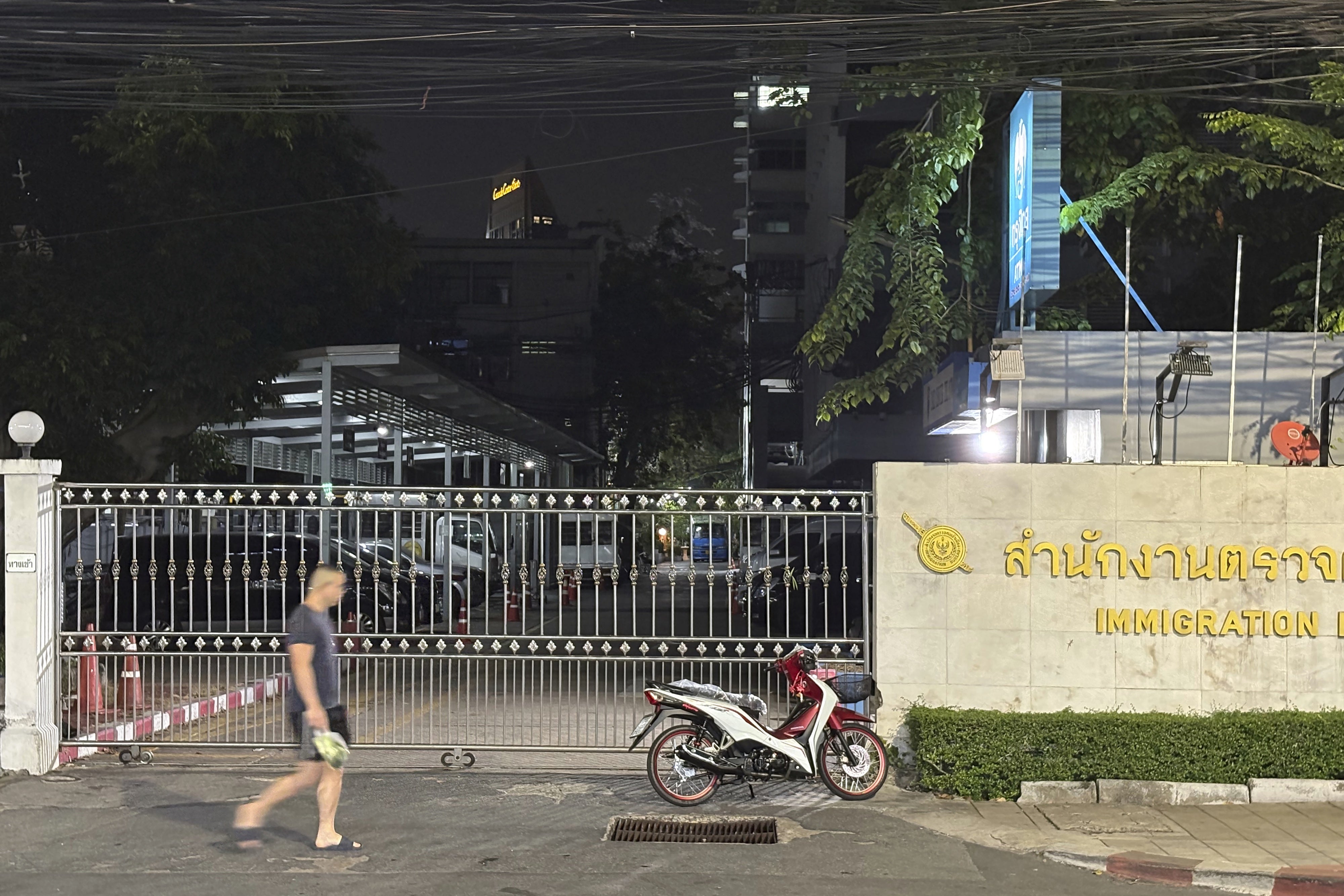Un homme marchait devant la grille d’un centre de détention pour immigrés à Bangkok, en Thaïlande, le 26 février 2025. 