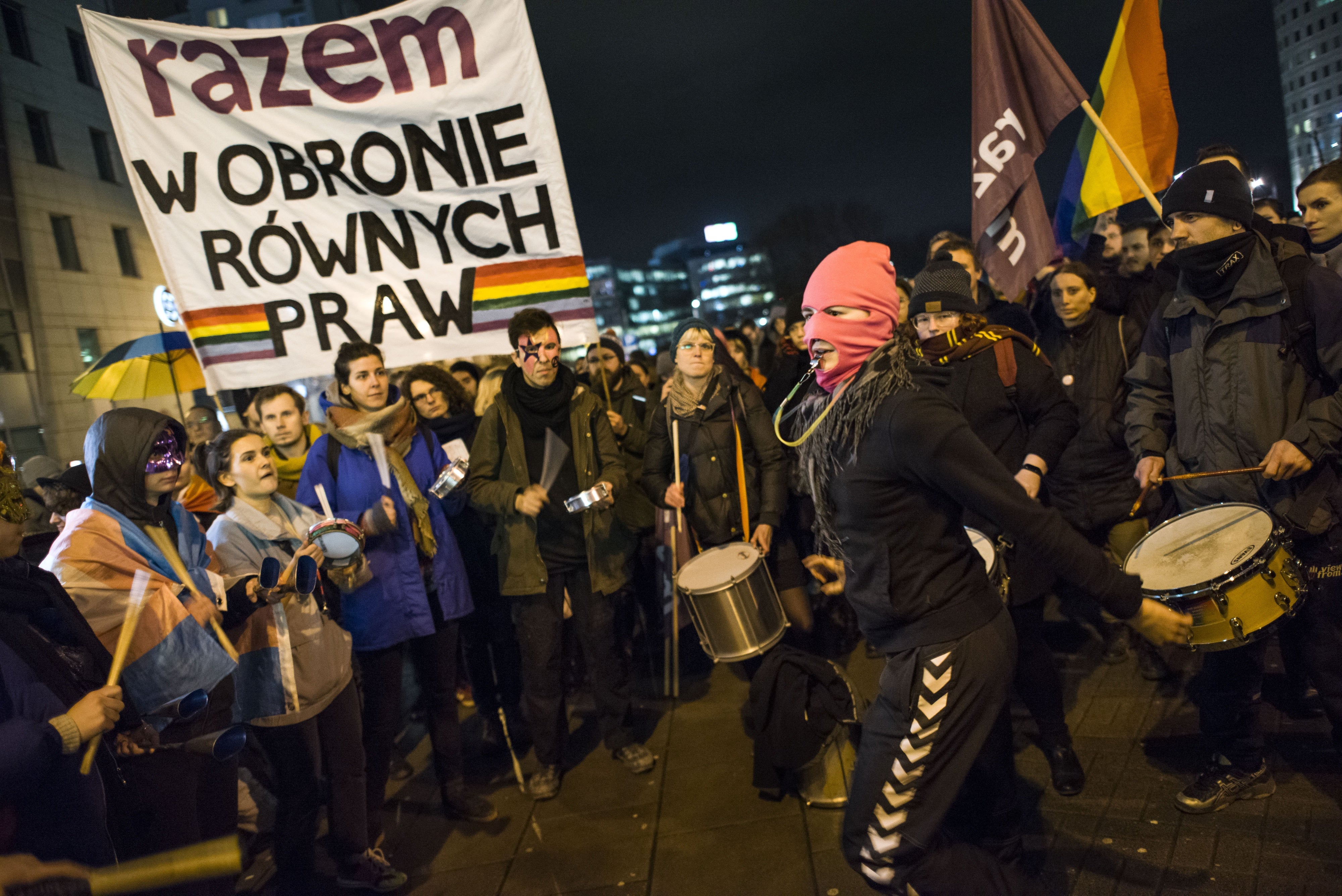 Activists raise a banner at a protest