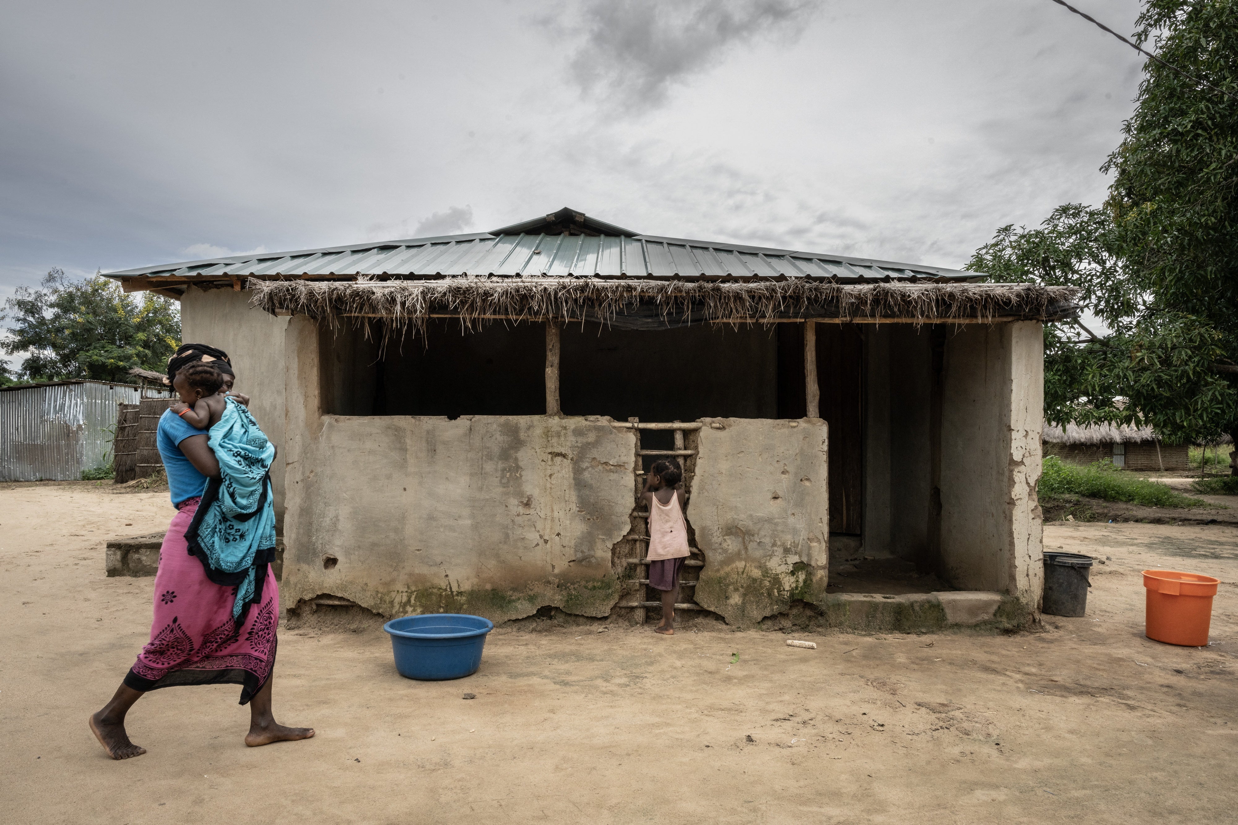 A mother walks with her daughters in the community of Saul, in the Metuge region of Cabo Delgado province, Mozambique, on March 26, 2024.