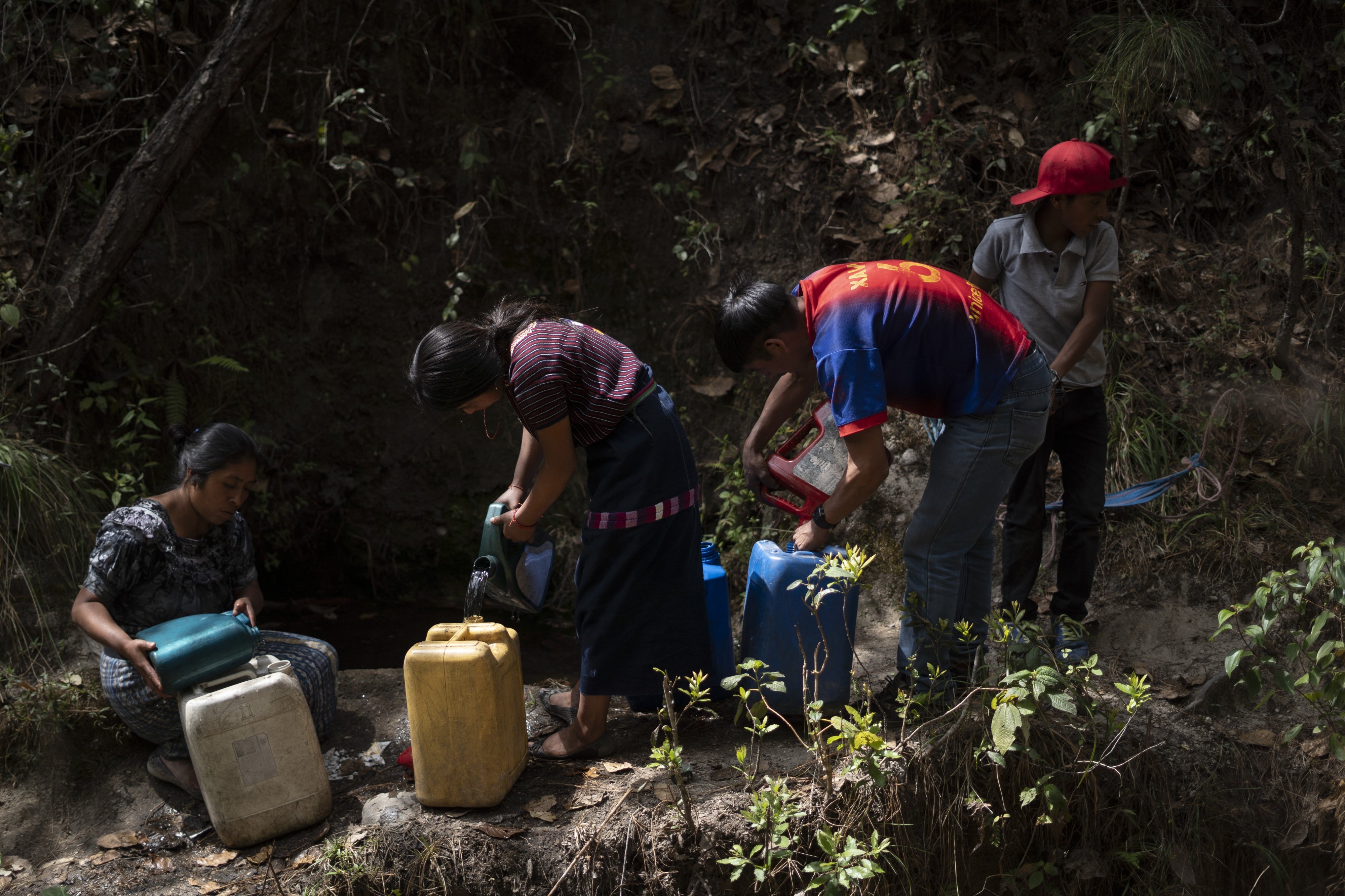 A family collects water in Santa María Chiquimula municipality, Totonicapán department. 