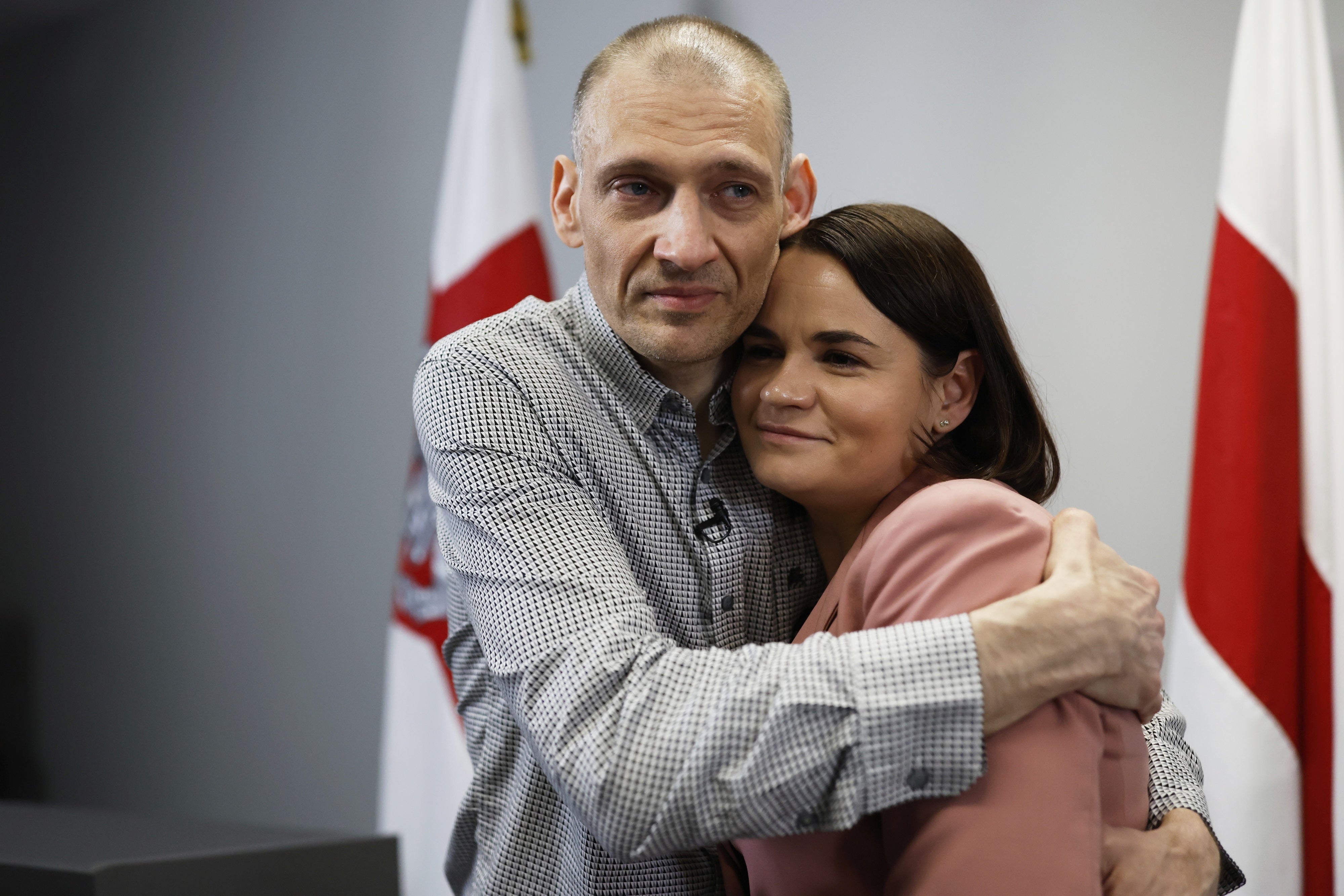 Belarusian opposition politician Syarhei Tsikhanouski (L), released from prison, embraces his wife, opposition leader Sviatlana Tsikhanouskaya, after a news conference in Vilnius, Lithuania, June 22, 2025. 