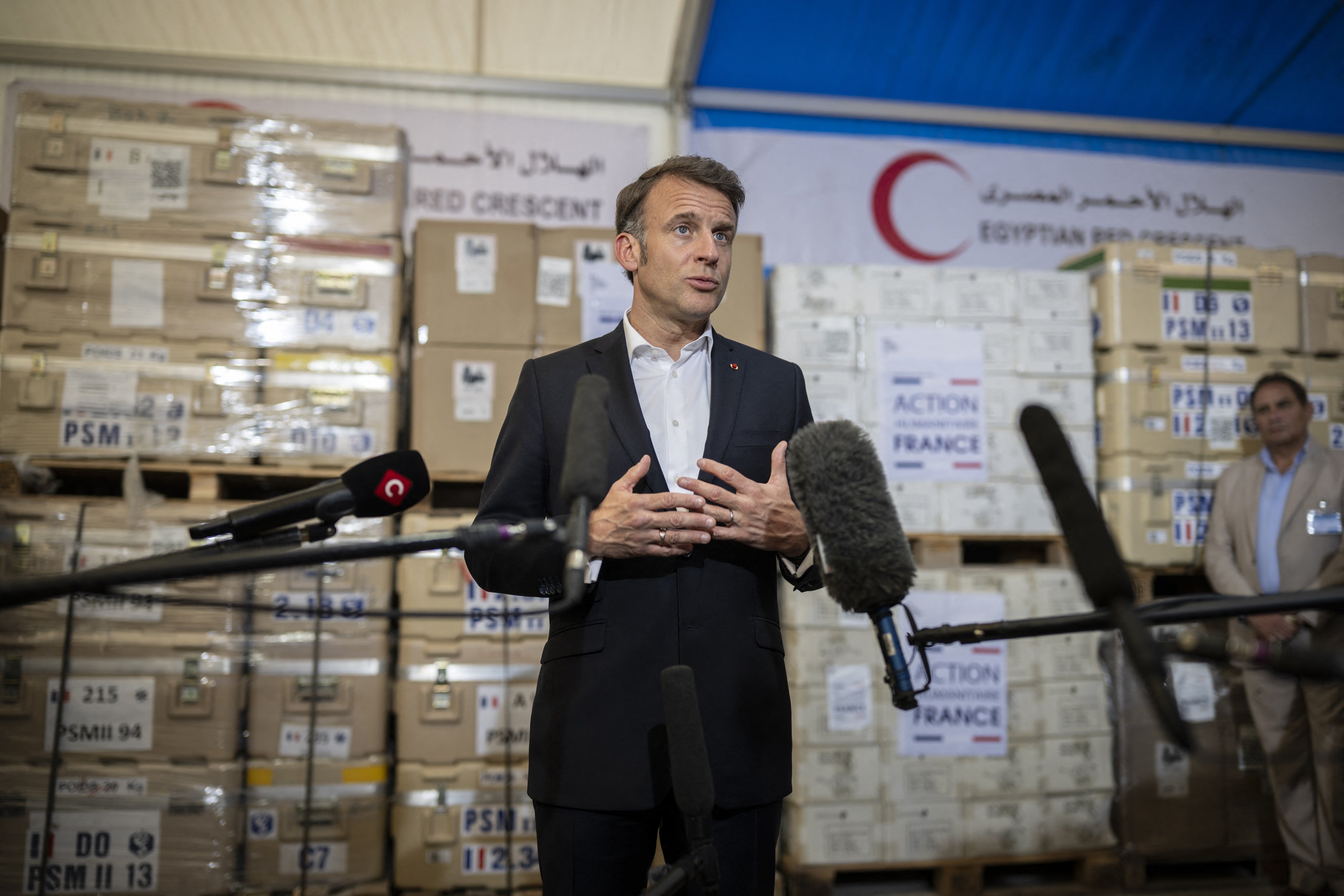 French President Emmanuel Macron talks to the media during a visit at Egyptian Red Crescent warehouses storing aid for Gaza, in the Egyptian border town of El-Arish, Egypt, on April 8, 2025.