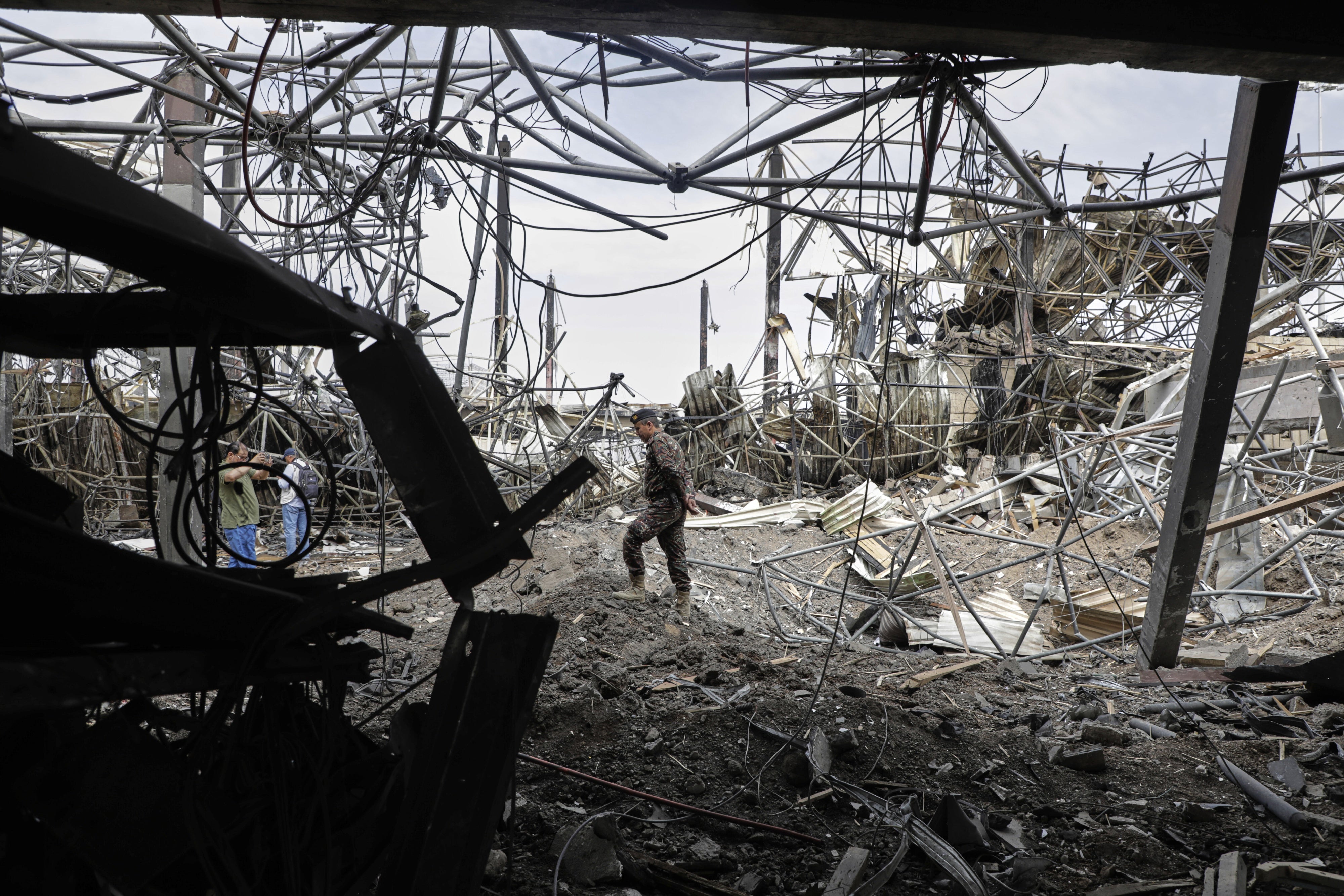 A Yemeni officer inspects the damage following Israeli airstrikes on Sanaa International Airport in Sanaa, Yemen, May 7, 2025.