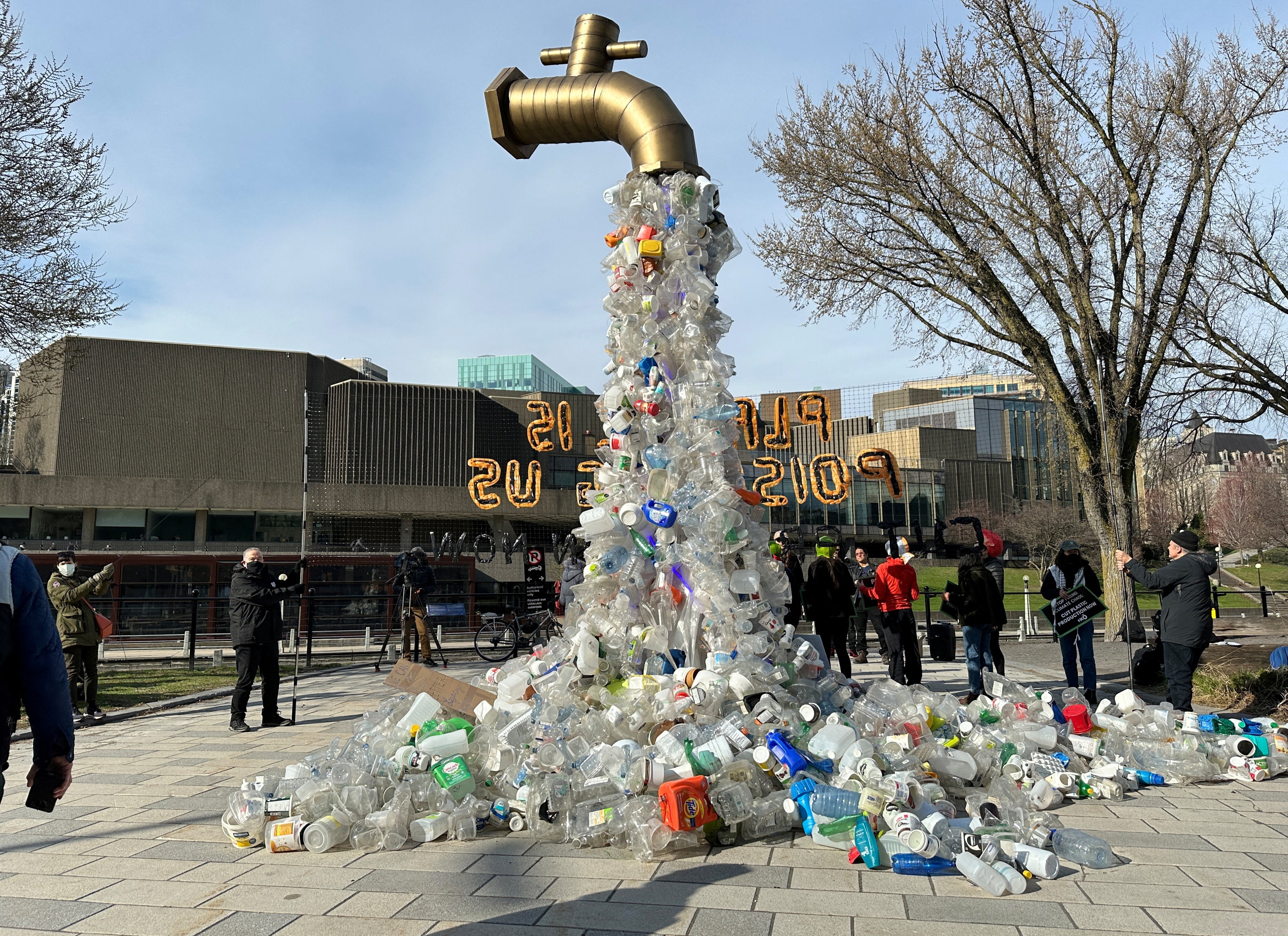 A prop depicting a water tap with cascading plastic bottles is displayed by activists near the Shaw Centre venue of negotiations for the global plastics treaty, in Ottawa, Canada, April 23, 2024.