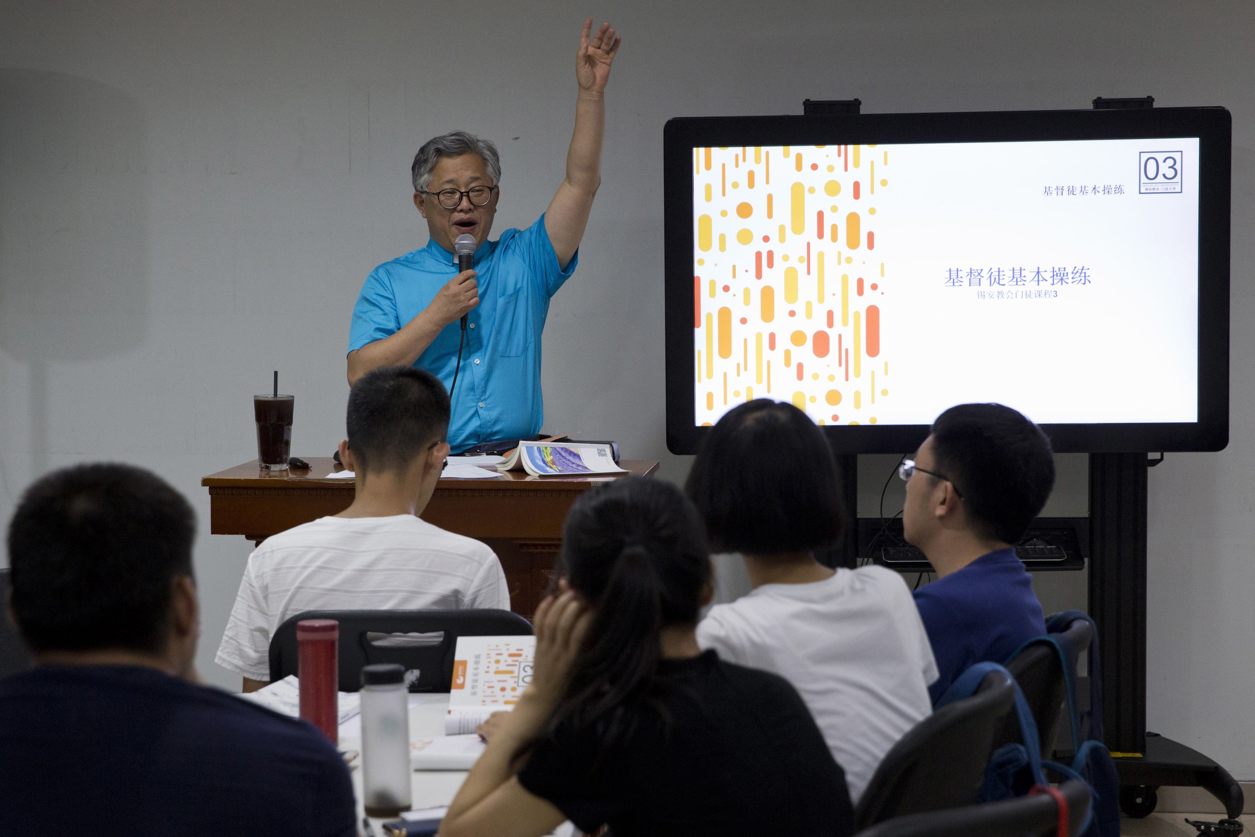 Jin Minri leads a class on the basics of Christian beliefs at the Zion Church in Beijing, China, August 4, 2018. 
