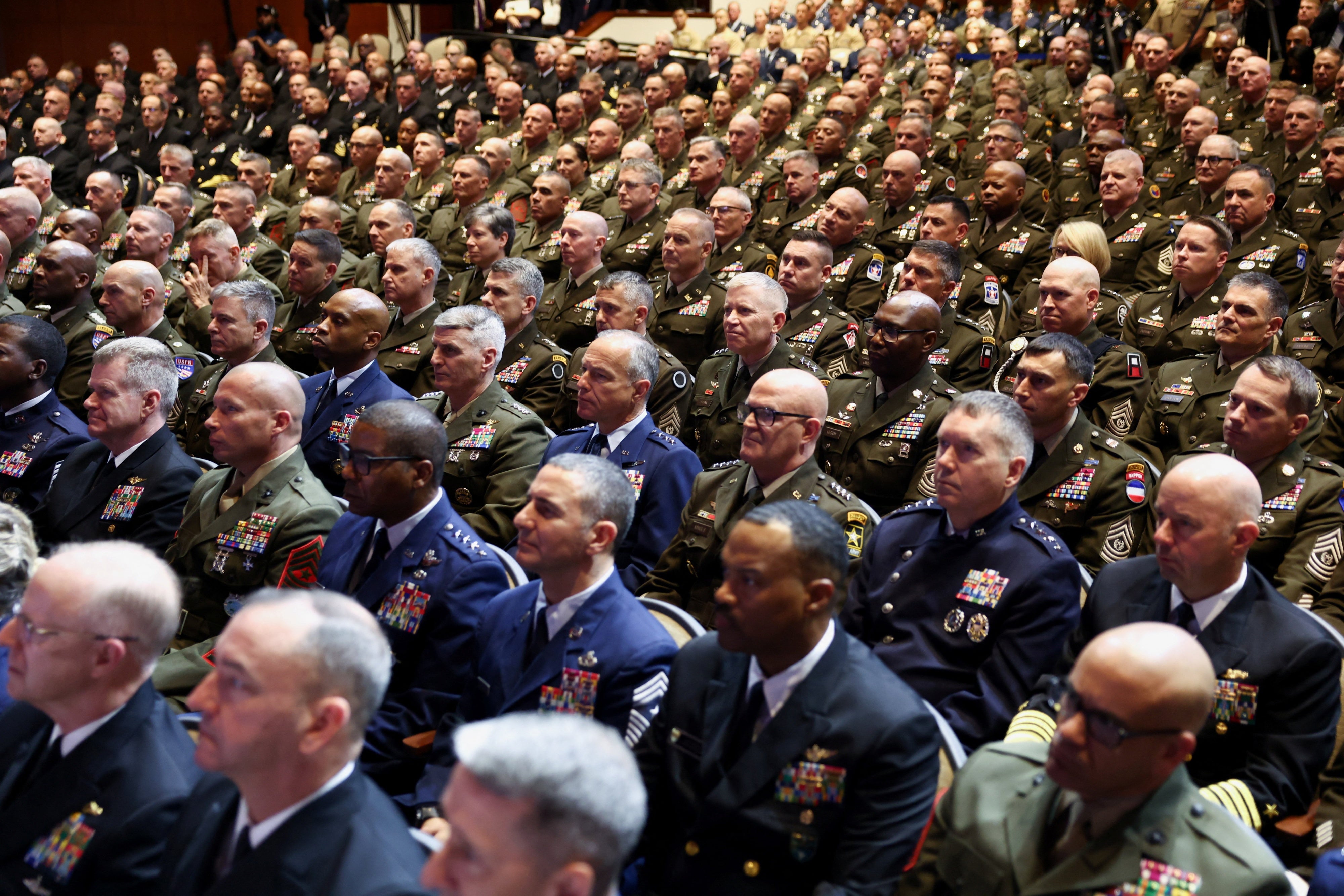 Members of the military attend a meeting convened by US Defense Secretary Pete Hegseth, at Marine Corps Base Quantico, in Quantico, Virginia, September 30, 2025.