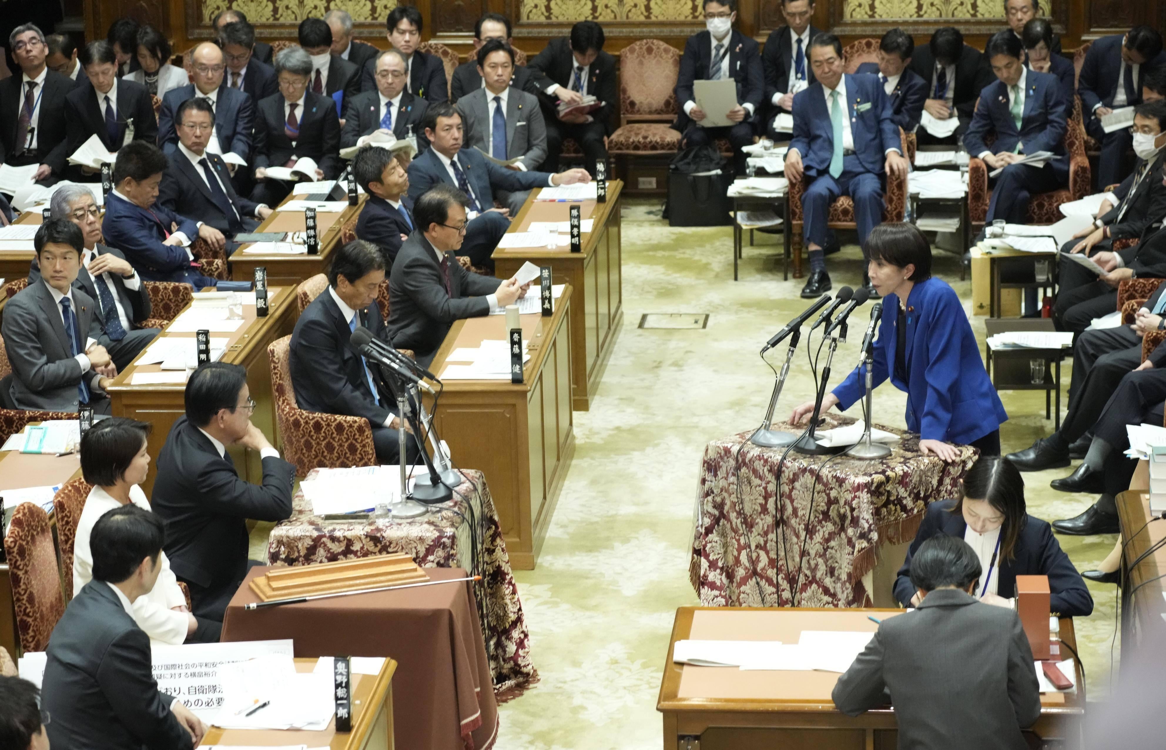 Japanese Prime Minister Sanae Takaichi (R) answers questions from the House of Representatives budget committee in Tokyo, November 7, 2025. 