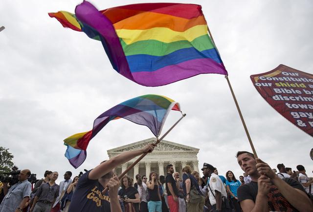Supporters of gay marriage wave the rainbow flag after the United States Supreme Court ruled on June 26, 2015, that the US Constitution provides same-sex couples the right to marry.