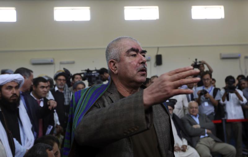 Abdul Rashid Dostum talks with his supporters at the Afghanistan's Independent Election Commission (IEC) in Kabul, Afghanistan, October 6, 2013.