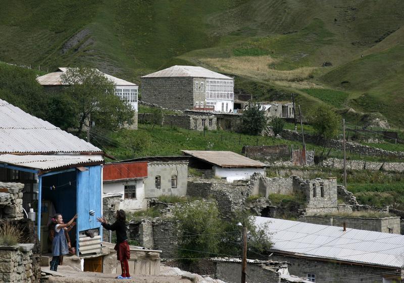 Two girls play ball in a mountain village of Dagestan in Russia's North Caucasus region, August 20, 2007.